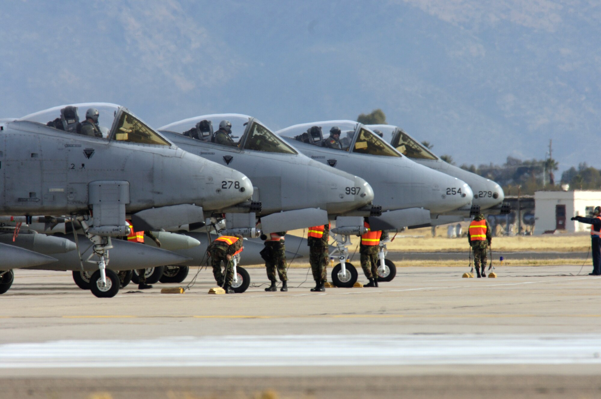 Pilots from the 354th Fighter Squadron prepare to take off in their A-10 Thunderbolt IIs to a simulated deployed location as a part of Bushwhacker 07-02 Jan. 21at Davis-Monthan Air Force Base, Ariz. Bushwacker 07-02 is an operational readiness exercise that tests the 355th Wing's ability to prepare deploy. (U.S. Air Force photo/Senior Airman Jesse Shipps)