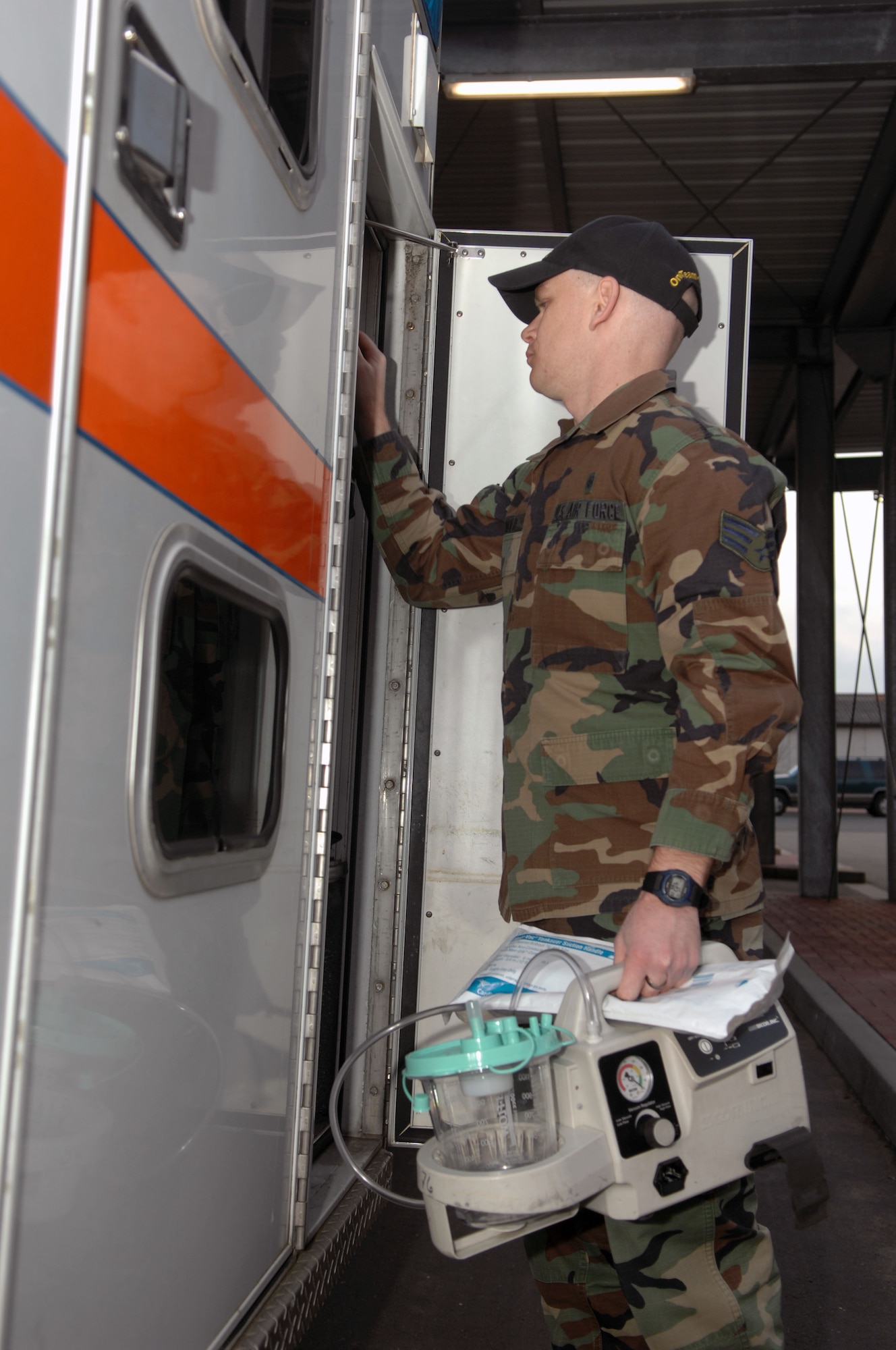 Senior Airman Wesley Arnold, a medic for the 435th Contingency Aeromedical Staging Facility, loads medical equipment into an ambulance before picking up a patient flown in from downrage Jan. 10. (U.S. Air Force photo/Senior Airman Megan Carrico)