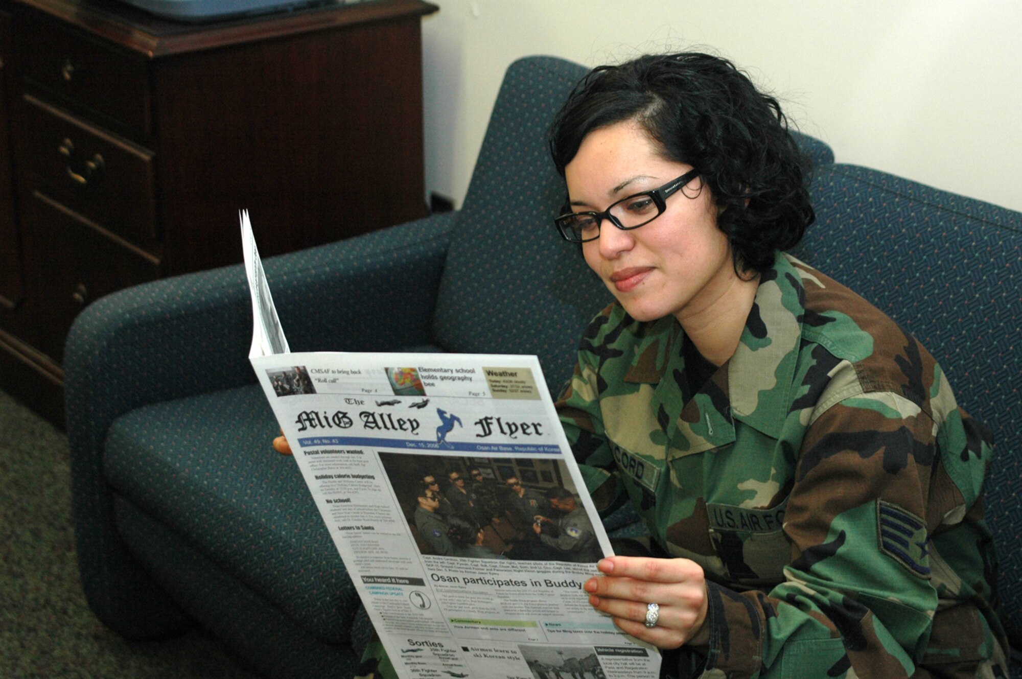 OSAN AIR BASE, Republic of Korea --  Staff Sgt. Vanessa Peddicord, 51st Mission Support Squadron, reads a previous edition of the MiG Alley Flyer
Wednesday. She, along with everyone else on base, may soon get their news about Osan online. How do you feel
about the Flyer going digital? Let us know, see the survey on Page 4. (U.S. Air Force photo by Senior Airman Brok McCarthy)
