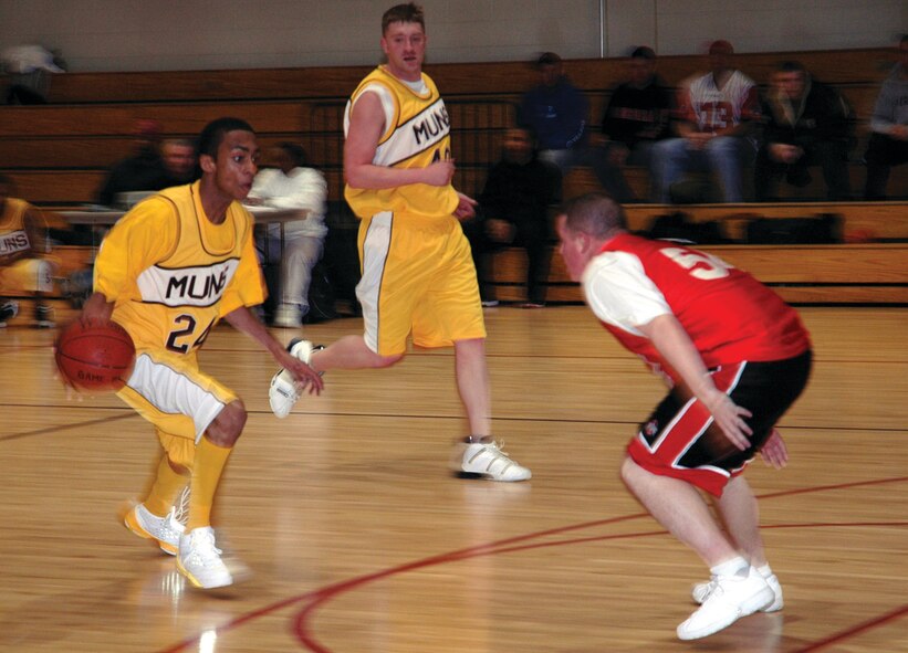 OSAN AIR BASE, Republic of Korea --  Roderick Henderson, left, and Adam Fralick, 51st Munitions Squadron (A Team), try to break past Tim Morgan, 5th Logistics Readiness Squadron. 51st MUNS went on to beat 5th LRS, 58-47. (U.S. Air Force photo by Staff Sgt. Benjamin Rojek)