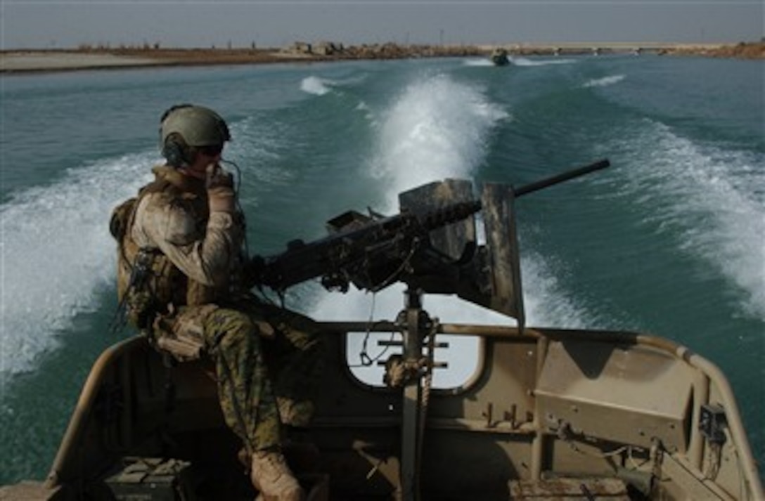A U.S. Marine from Dam Security Unit III mans a weapon aboard a small unit riverine craft during a reconnaissance mission on Lake Habbaniyah in Iraq on Jan. 10, 2007.  Marines from the Security Unit are deployed with 1st Marine Expeditionary Force (Forward) in support of Operation Iraqi Freedom.  