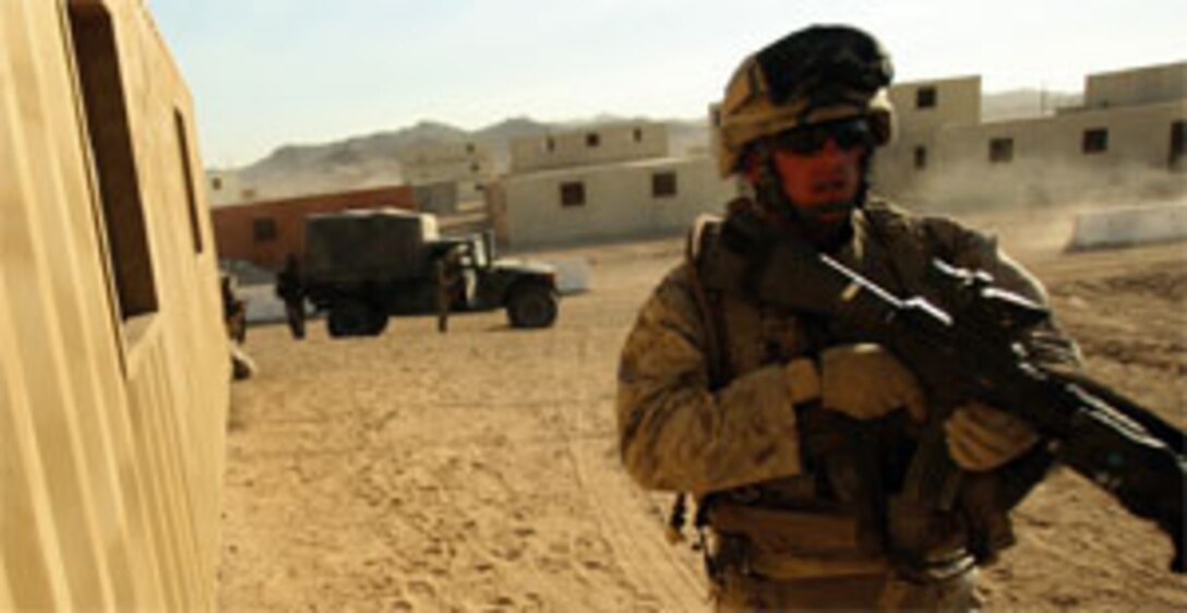 Sgt. James A. Whitwan, 25, with Company I, patrols across an opening to cover his Marines during a cordon and search.
