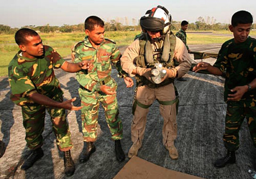 U.S. Marine helicopter crews from the 22nd Marine Expeditionary Unit, embarked with the USS Kearsarge, deliver bottled to Barisal, Bangladesh, Nov. 23, 2007. The shipment marked the beginning of U.S. military humanitarian aid to the cyclone-stricken country.
