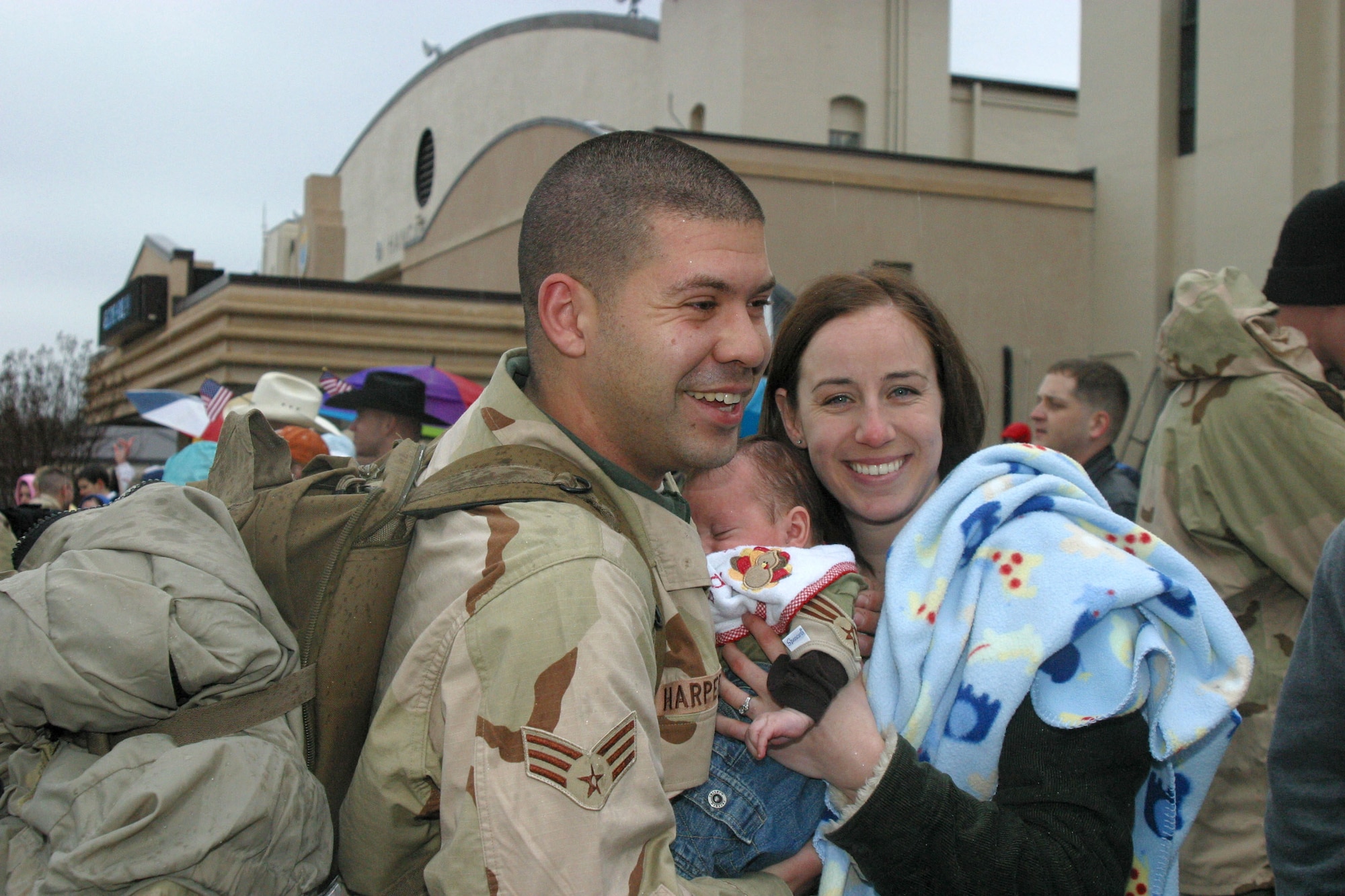 Senior Airman Kory Harper is welcomed home by his wife, Pam Harper, as he sees their 10-week-old son, Clark Alexander Harper, for the first time Jan. 21 at Pope Air Force Base, N.C. Airman Harper is an A-10 crew chief with the 23rd Fighter Group and was deployed for several months supporting the war on terrorism.  (U.S. Air Force photo/Staff Sgt. Cassandra Locke)
