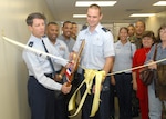 Brig. Gen. Darrell Jones uses a giant pair of scissors to cut a ribbon to dedicate the new Lackland Air Force Base Tax Center in the Carswell Administration Building, Bldg. 9050, Suite 3700. Standing beside General Jones, then the 37th Training Wing commander, is 1st Lt. Eric Adams, officer in charge of the center. The center will open Feb. 5, 2007. The building, at 1700 Carswell Ave., is near clothing sales on Hughes Avenue at Kirtland Street. Hours of operation will be 8-11 a.m. and 1-3 p.m. Monday through Thursday. Appointments are required for all but basic military trainees and technical school students by calling 671-7983 starting Monday. Also, each unit has at least one tax advisor ready to assist with federal income tax returns. 