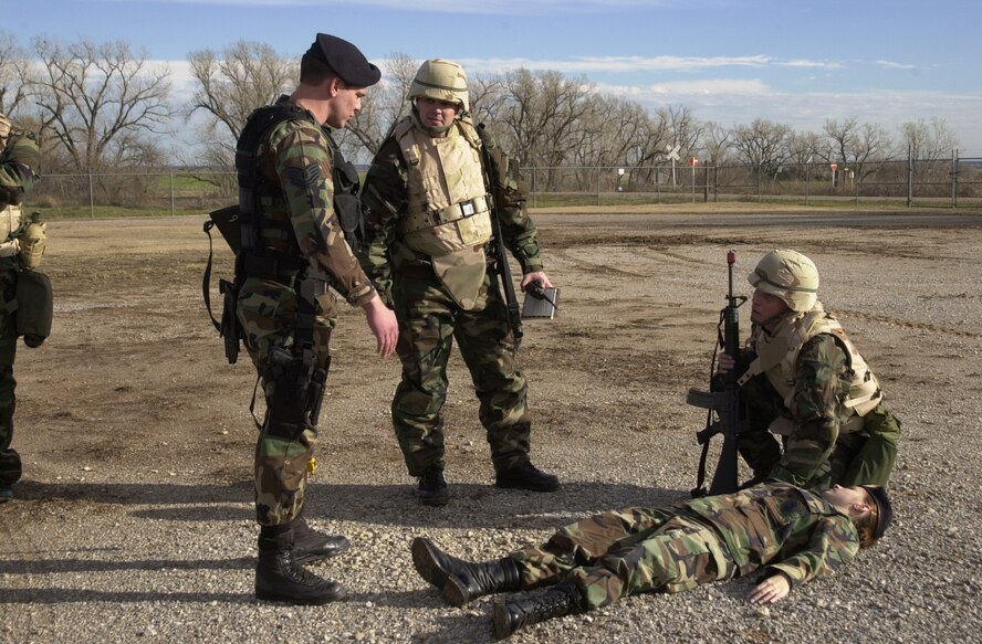 (Photo by SSgt Amanda Mills) TSgt Scott Henshaw, 71st Security Forces Squadron, questions MSgt Wade Terrell and SSgt David Counts, 71st Operations Support Squadron, as they evaluate and care for a “victim” during training Dec. 8.