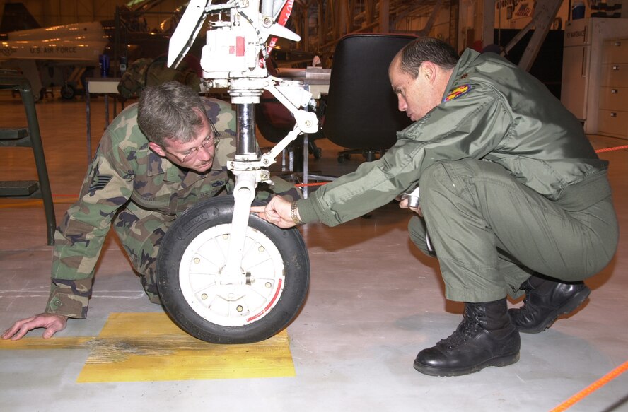 (Photo by Frank McIntyre) TSgt Bruce Bare and Maj Kenneth Coons, 71st Flying Training Wing safety office members, inspect the tire of a mishap aircraft, a usual task for the command-level award-winning office.