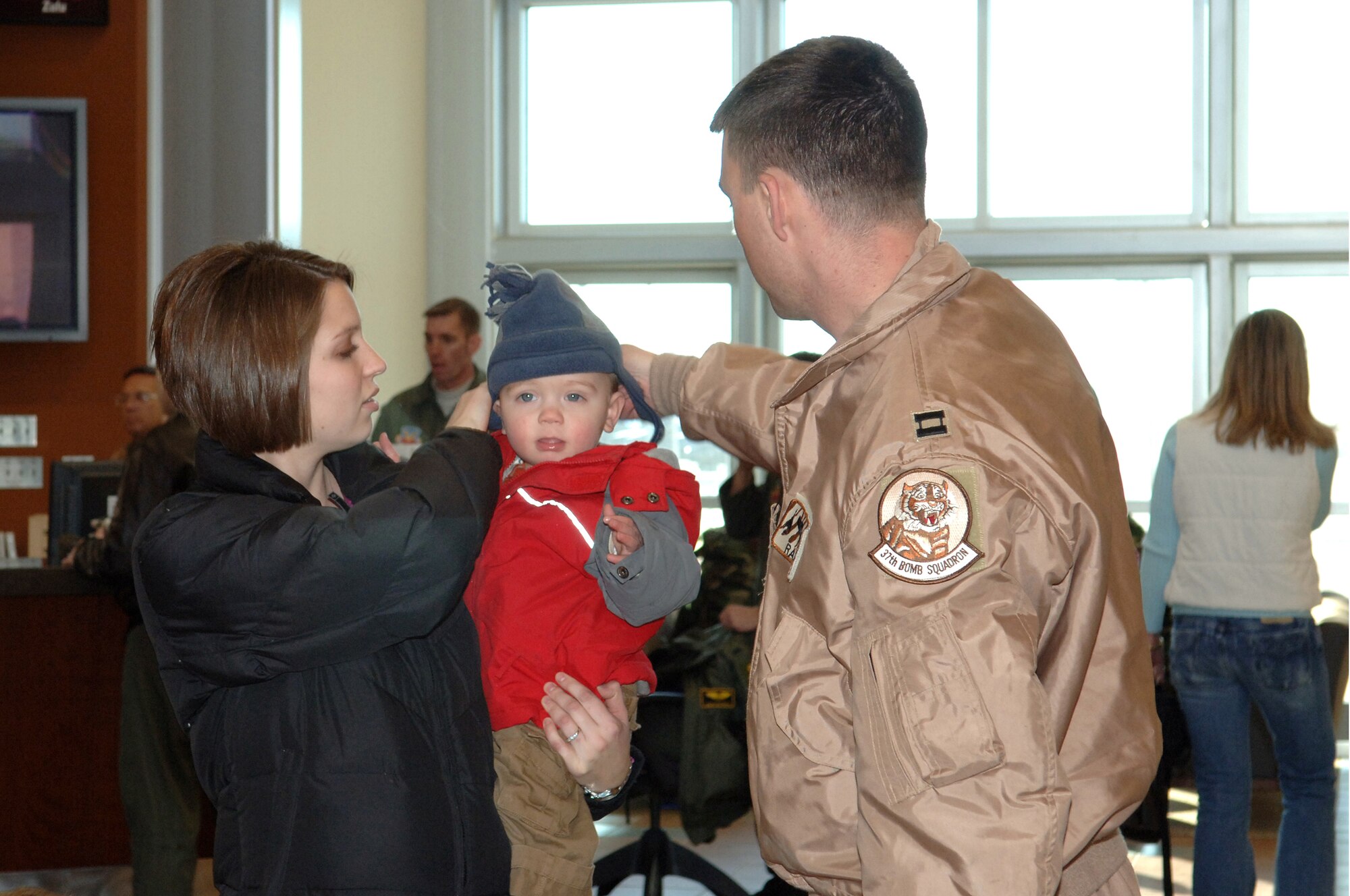 Capt. Zack Stewart returns home from a five-month deployment to Southwest Asia and is welcomed by his wife and children Jan. 21 at Ellsworth Air Force Base, S.D. Captain Steward was deployed to Southwest Asia in support of operations Iraqi Freedom and Enduring Freedom. He is a B-1 Lancer pilot with the 28th Bomb Wing. (U.S. Air Force photo/Airman 1st Class Angela Ruiz)