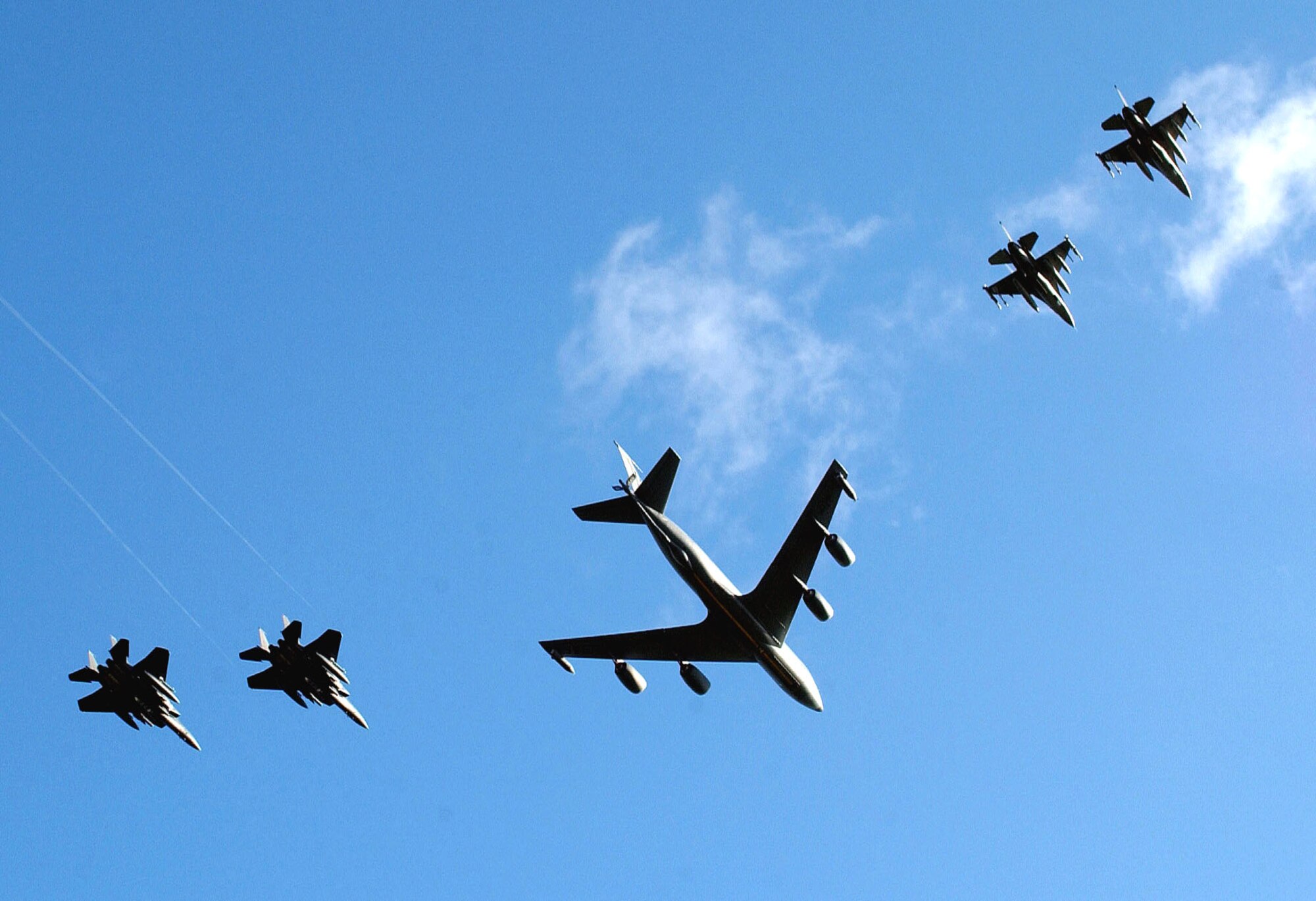 Air Force tankers, such as this KC-135 Stratotanker, keep Air Force fighters such as these F-16 Fighting Falcons and F-15E Strike Eagles in the fight.  (U.S. Air Force photo by Staff Sgt. Valerie Smith)