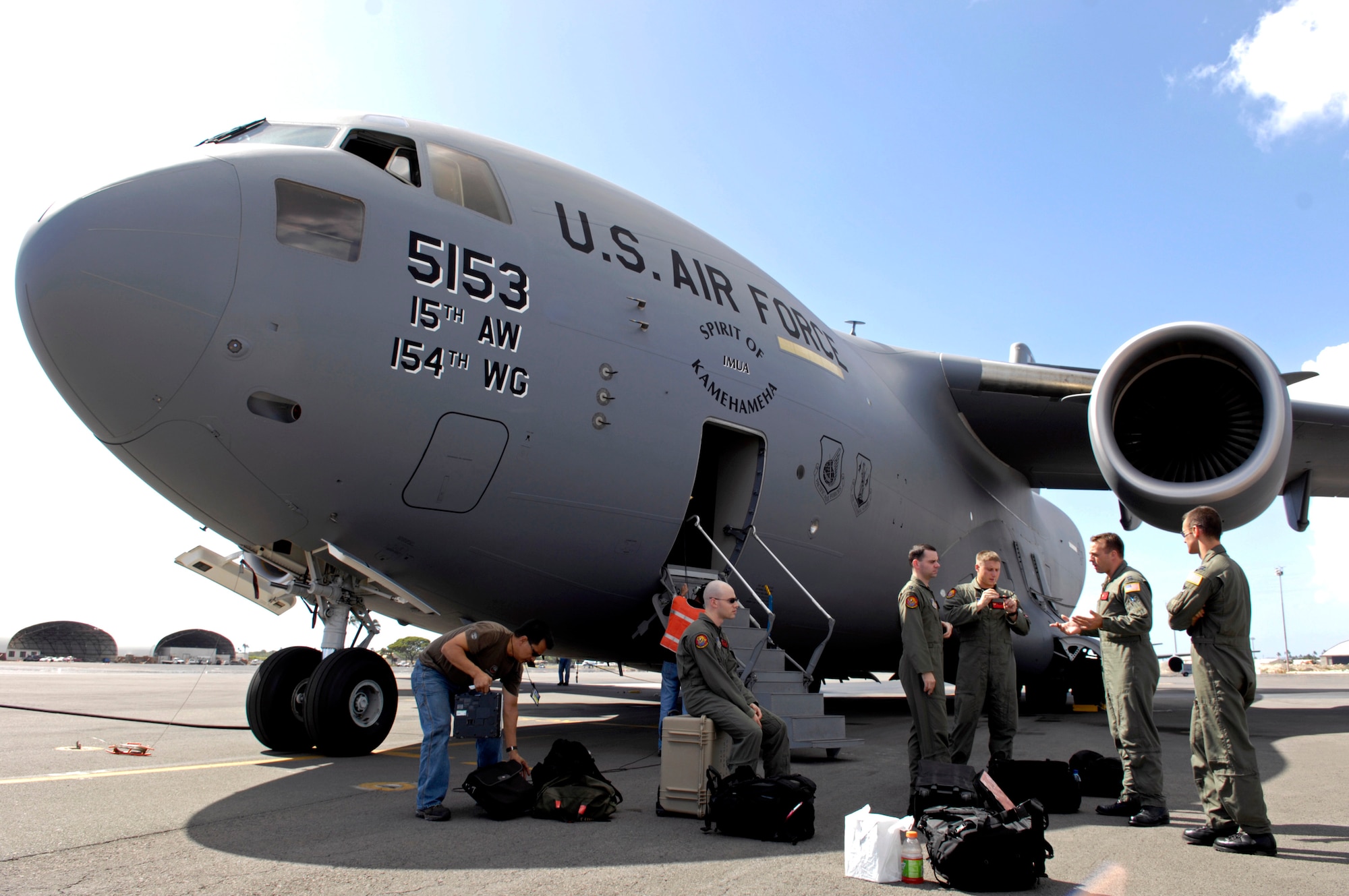 Pilots from the 535th Airlift Squadron from Hickam Air Force Base, Hawaii, conduct a quick post flight briefing after returning from a local training mission Jan. 19 over the Hawaiian Islands. (U.S. Air Force photo/Tech. Sgt. Shane A. Cuomo) 
