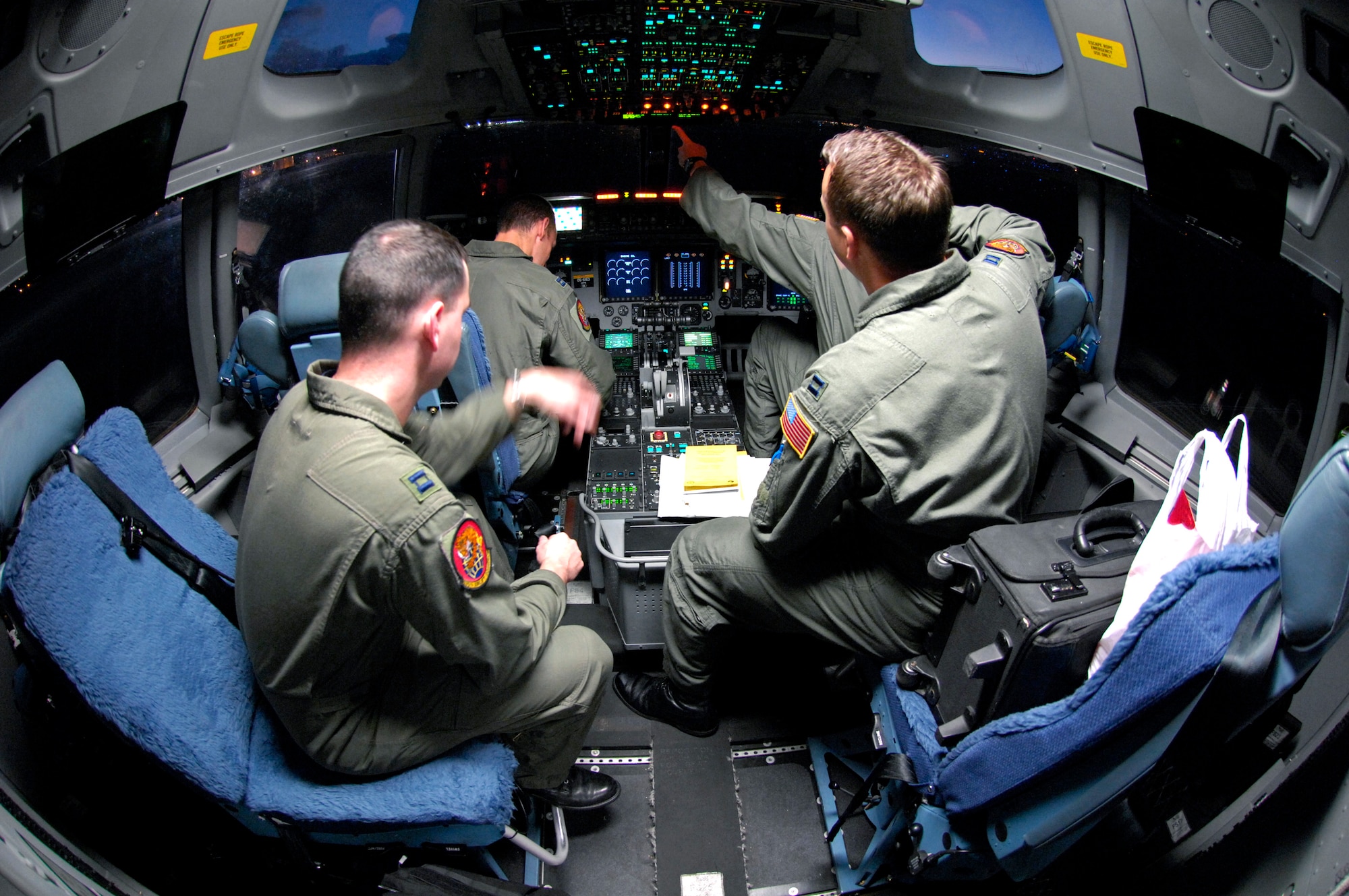 Pilots from the 535th Airlift Squadron conduct preflight checks on their C-17 Globemaster III prior to taking off Jan. 19 on a local training mission from Hickam Air Force Base, Hawaii. The aircraft can perform tactical airlift and airdrop missions and can also transport litters and ambulatory patients during aeromedical evacuations when required. (U.S. Air Force photo/Tech. Sgt. Shane A. Cuomo) 
