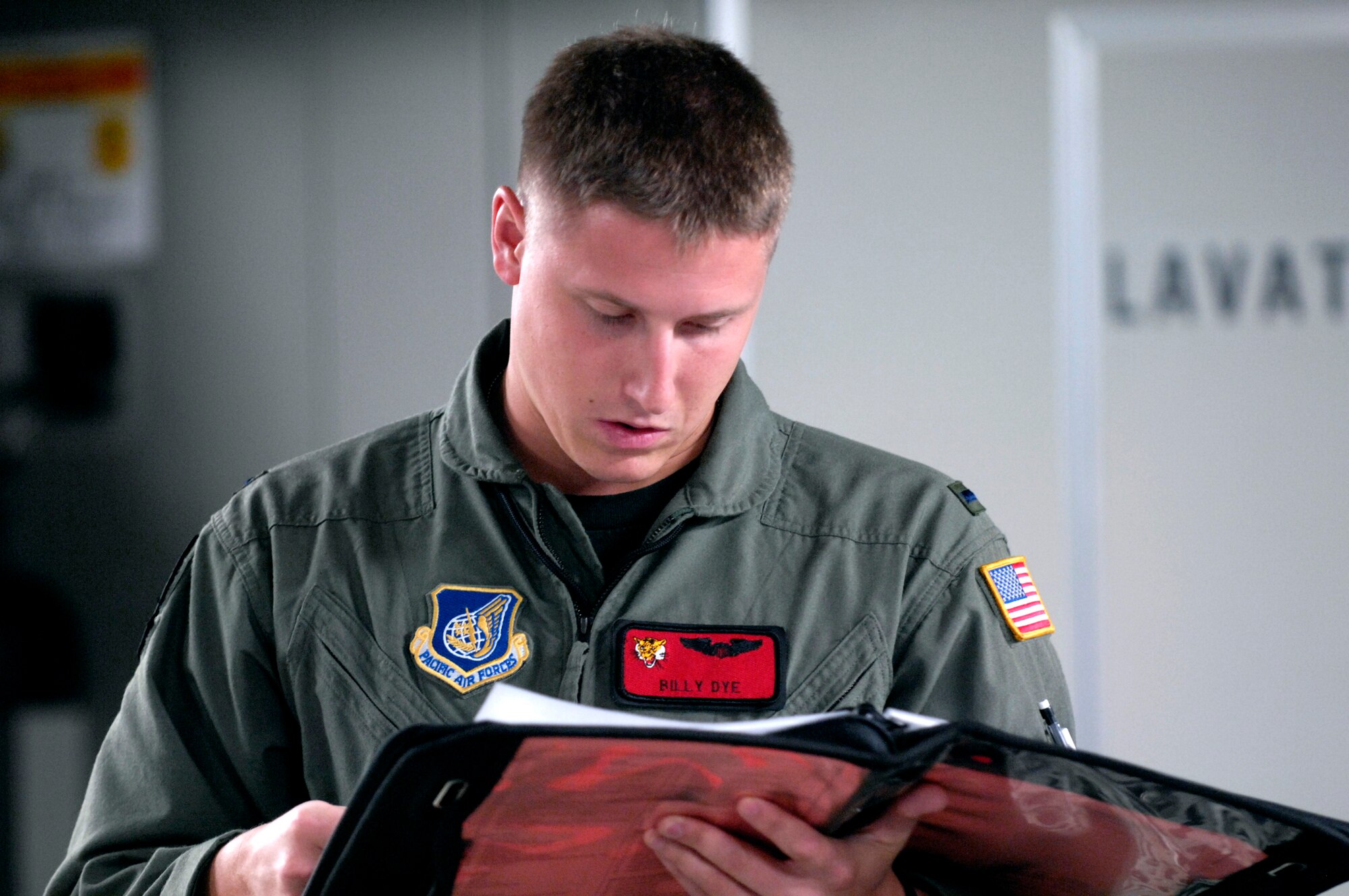 1st Lt. Billy Dye looks over a logbook during a pre-flight inspection on a C-17 Globemaster III Jan. 19 at Hickam Air Force Base, Hawaii. Lieutenant Dye is a pilot with the 535th Airlift Squadron. (U.S. Air Force photo/Tech. Sgt. Shane A. Cuomo)
