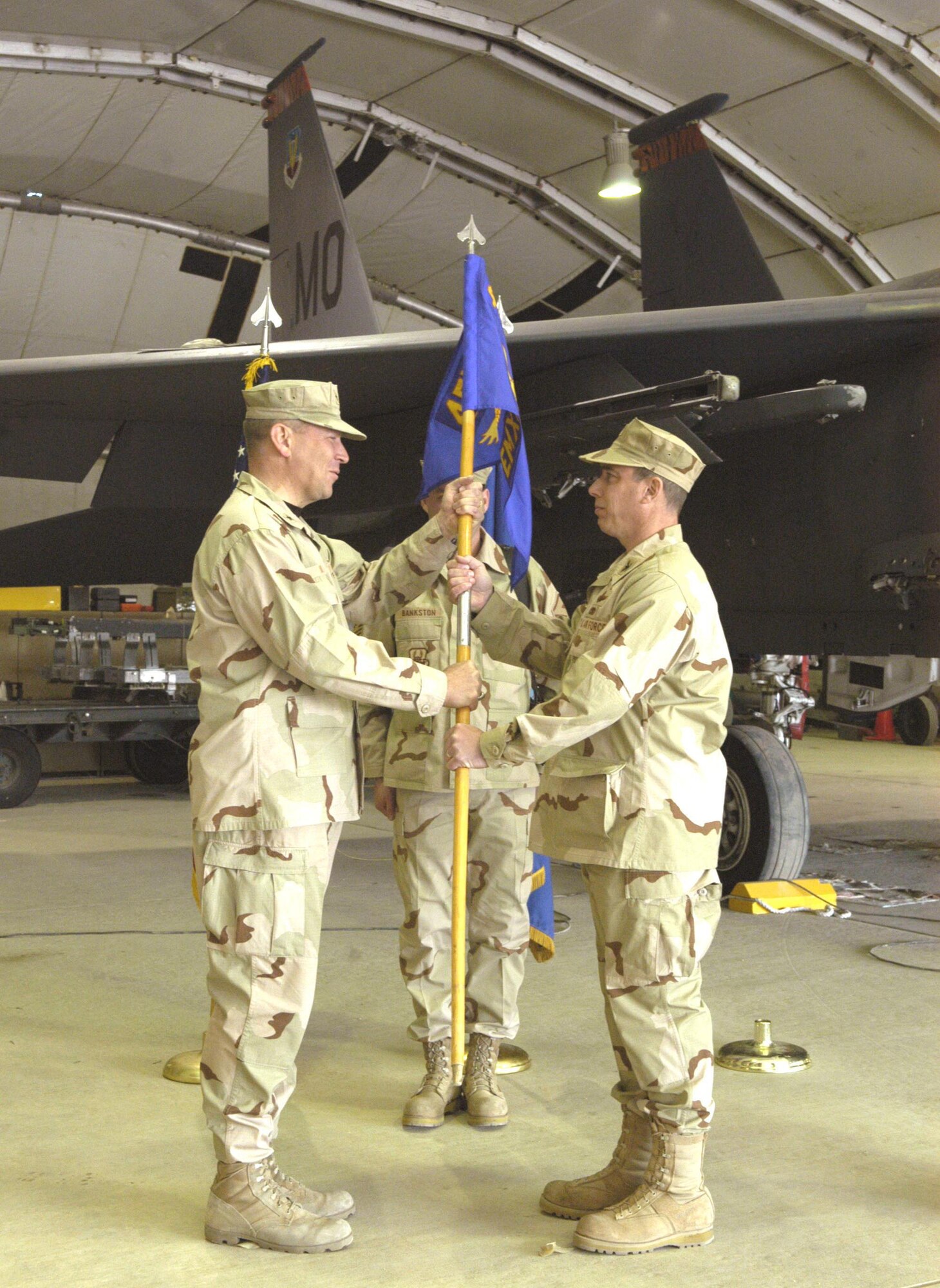 Col. Frank Stokes accepts command of the 455th Expeditionary Maintenance Group from Brig. Gen. Christopher Miller, 455th Air Expeditionary Wing commander, during a ceremony Jan. 21. (U.S. Air Force photo/Staff Sgt. Kevin Tomko)