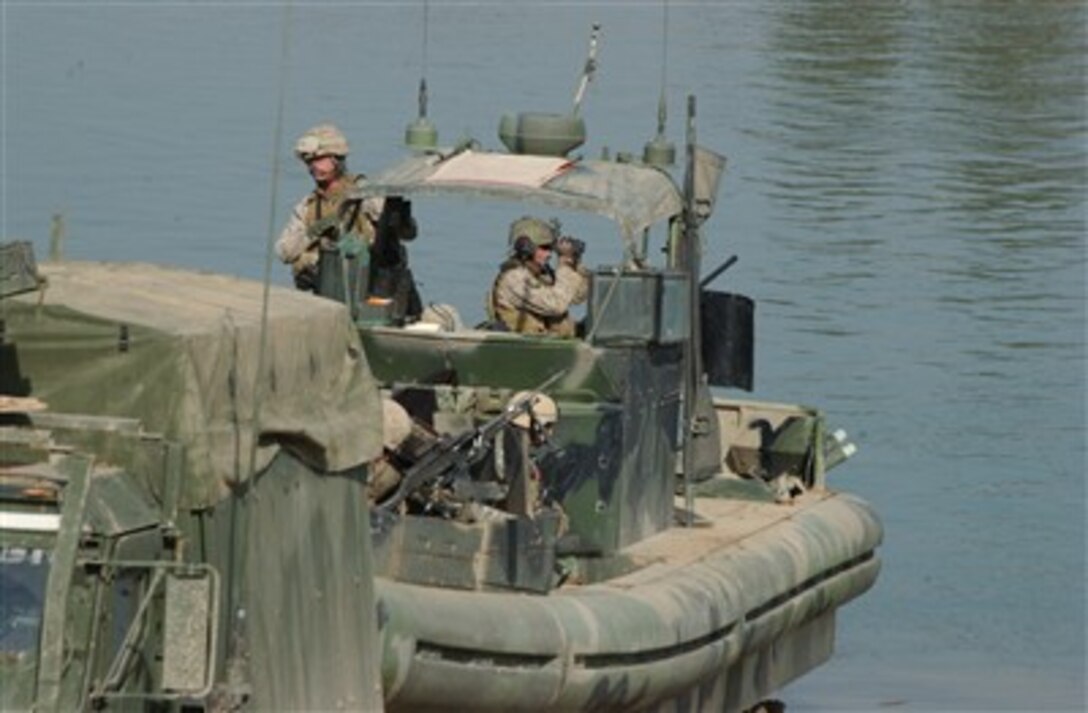 A U.S. Marine from Dam Security Unit III pulls security while his small unit riverine craft is inserted for a recon mission at Lake Habbaniyah, Iraq, Jan. 10, 2007. Marines from DSU III are deployed with I Marine Expeditionary Force (Forward) in support of Operation Iraqi Freedom in the Al Anbar province of Iraq.