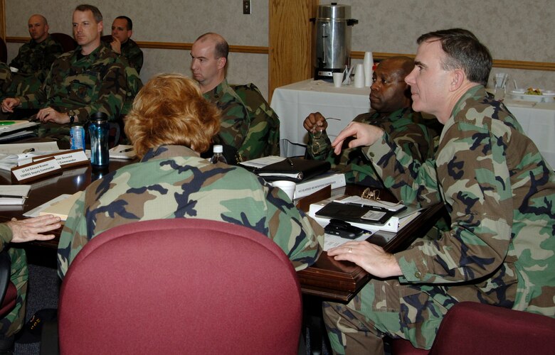 Brig. Gen. Robert McMahon, right, director of logistics, Air Mobility Command headquarters, Scott Air Force Base, Ill., sits at the head of the table in the 22nd Maintenance Squadron conference room in Bldg. 1169, Jan. 18, during a conference about Air Force Smart Operations 21 initiatives for maintenance units at McConnell Air Force Base, Kan. During the two-day conference, which ran from Jan. 17-18, representatives from bases around the globe met and discussed the initiatives they’ve implemented and the steps they plan to take to cut out unnecessary and time-consuming processes in the maintenance field. Air Force photo by Senior Airman Jamie Train, 22nd Communications Squadron