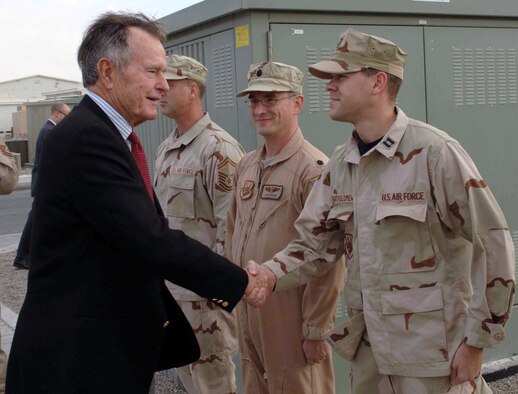 Capt. (Dr.) Dean Bartholomew, 90th MDOS, shakes hands with President George H. W. Bush, Nov. 20, 2006.  President Bush paid a surprise visit to the base where Dr. Bartholomew was stationed in Southwest Asia.  