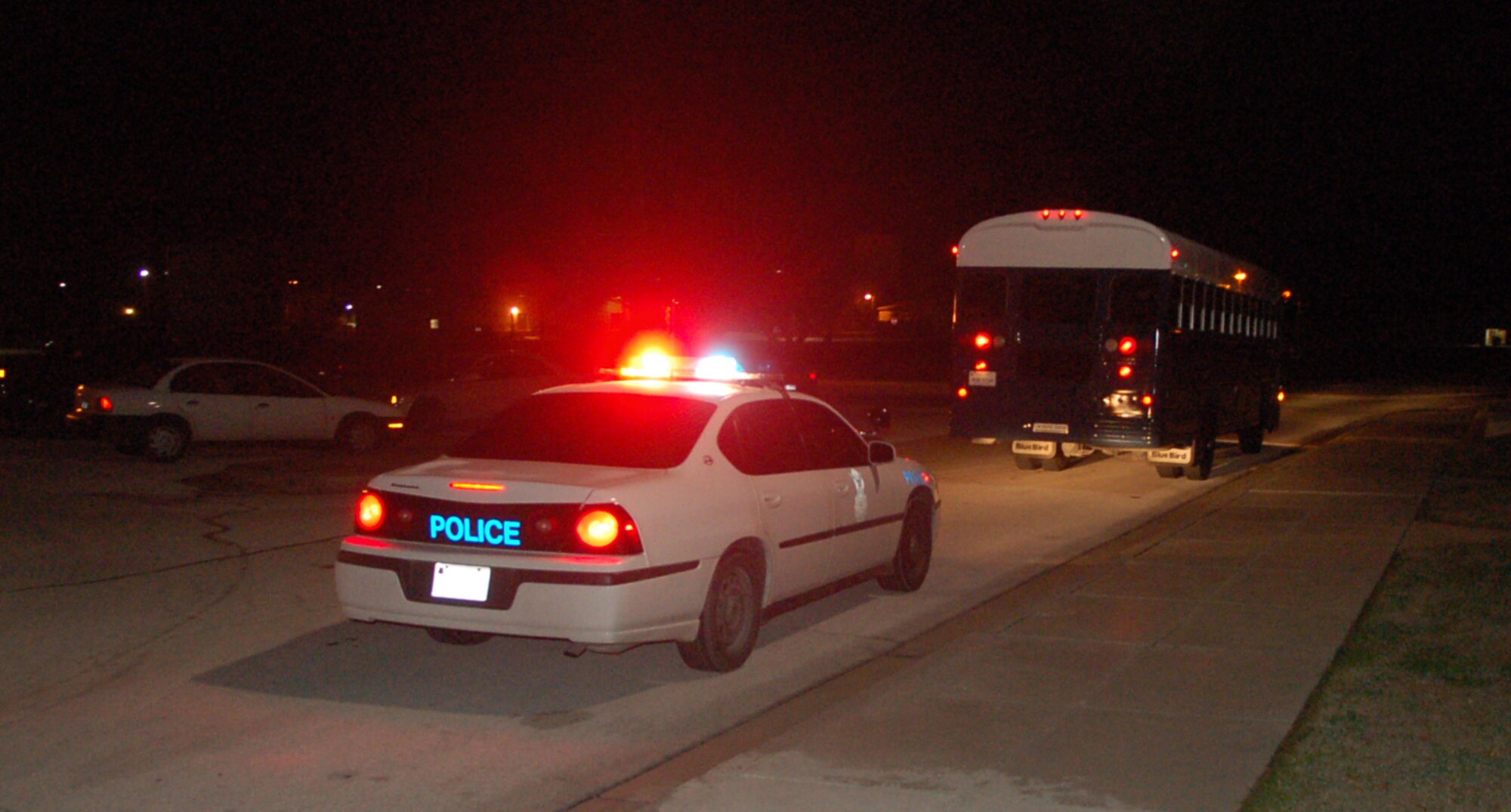 LAUGHLIN AIR FORCE BASE, Texas -- As a send-off to the 14 XLers deploying to various bases in Southwest Asia Jan. 21, vehicles from the 47th Security Forces Squadron escort their bus off base under flashing lights and a blaring siren while a crowd of more than 100 well-wishers cheered the departing warfighters.   (U.S. Air Force photo by Staff Sgt. Austin May)