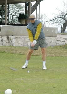 Chaplain (Capt.) Leif Espeland drives for "Team God" in an African-American Heritage Committee golf tournament Jan. 12 that was a "huge success" and raised approximately $1,900 for scholarships, said Shirley Jones, AAHC coordinator at Lackland Air Force Base, Texas. Chaplain Espeland, shown on No. 1 tee at Gateway Valley Golf Course, was one of 120 people who played for 30 teams in the tournament. Among the participants was San Antonio City Councilman Art Hall, who said he loves to golf and was happy the AAHC invited him. (USAF photo by Alan Boedeker)                                 