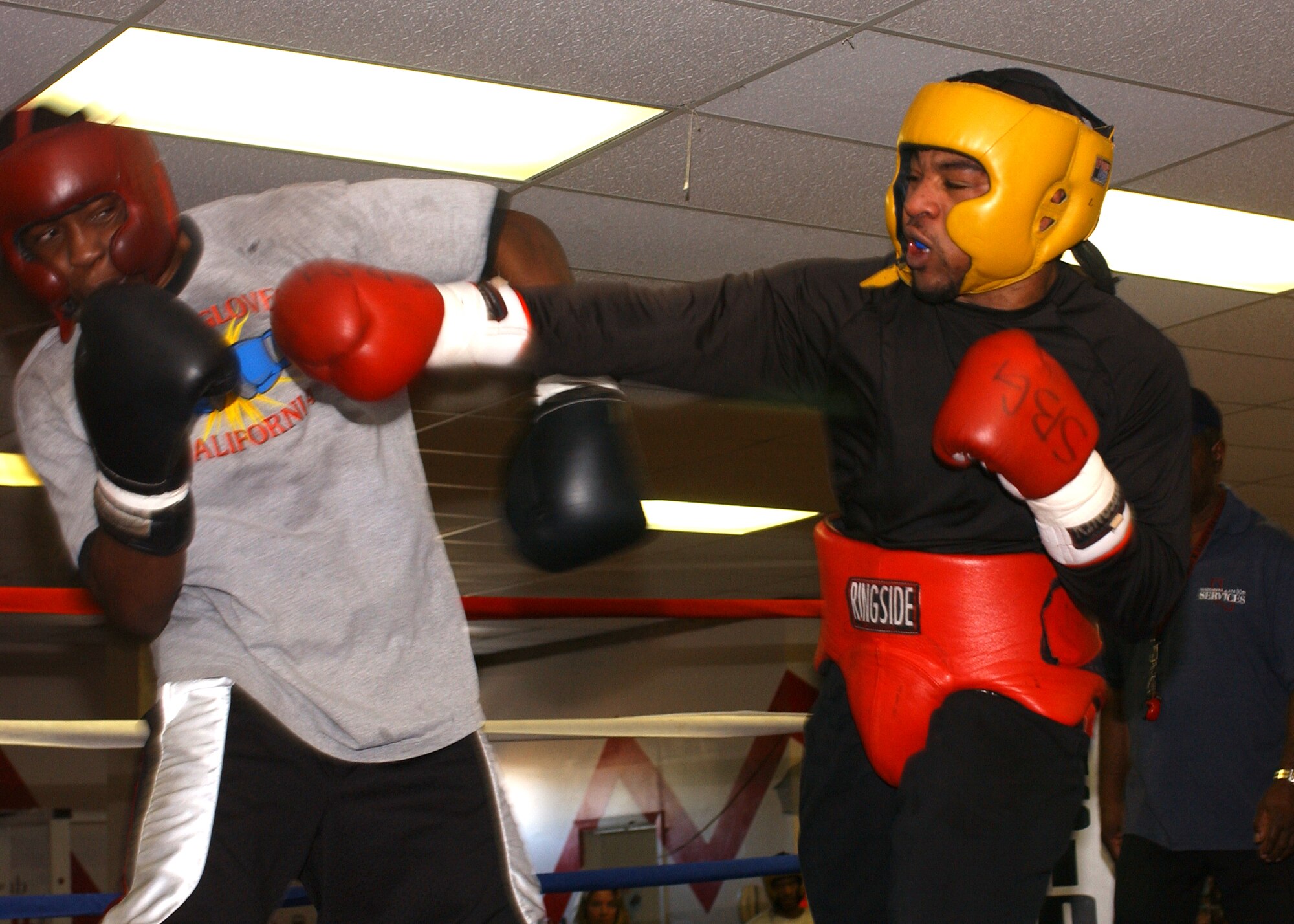 Elliot Seymour (left) of the United States Navy Covers as a punch is thrown by Mylin Wyche (right) at the Vandenberg Boxing Center on Jan. 20.  (United States Air Force Photo by Airman Adam Guy)   
