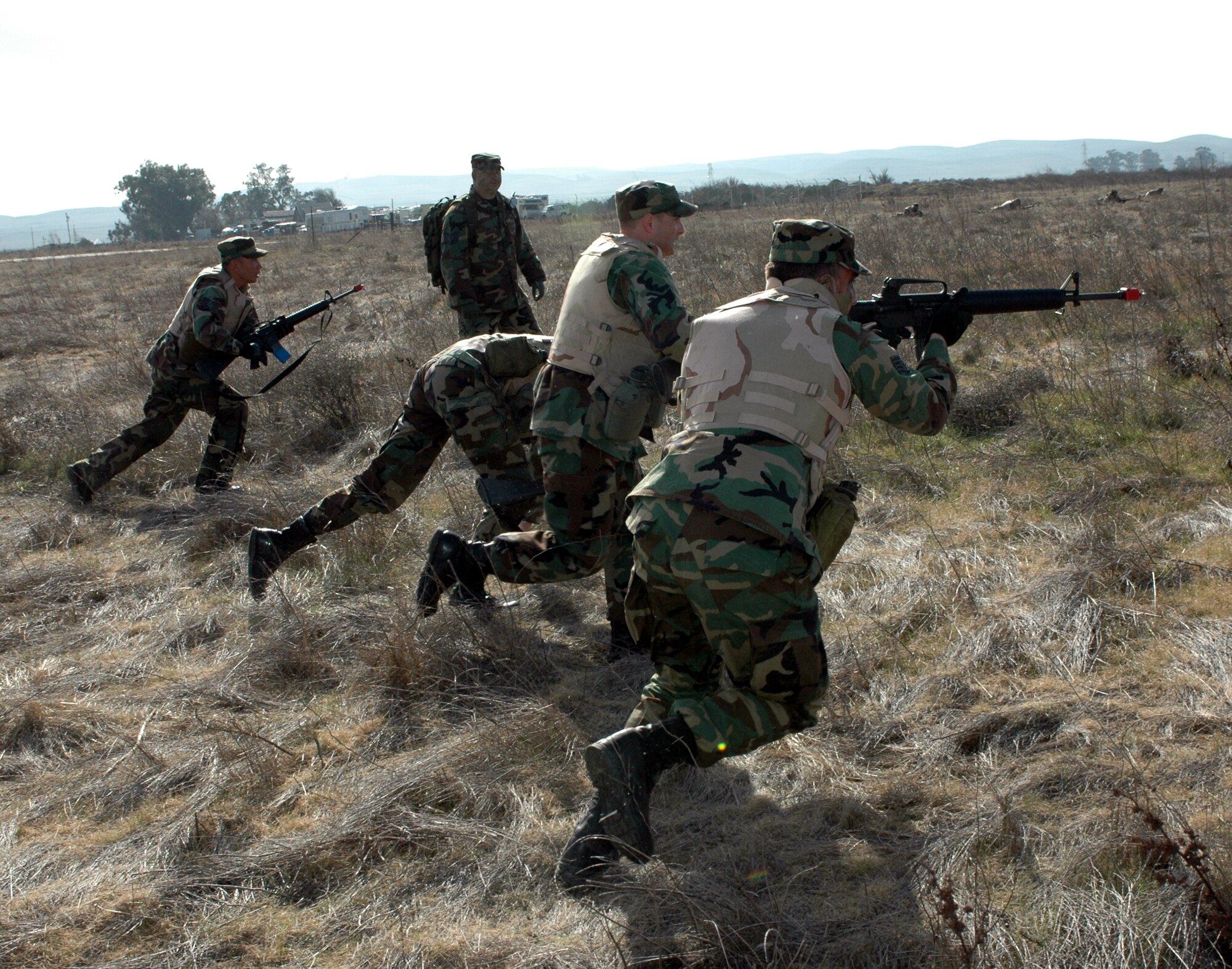 Members of Squad Team #2 advance on “insurgents” during the Combat Skills Training course. Designed to teach students basic combat survival techniques, the course uses scenarios such as fire fights to enhance students’ reaction and to add realism to the training. (U.S. Air Force photo by Staff Sgt Candy Knight)