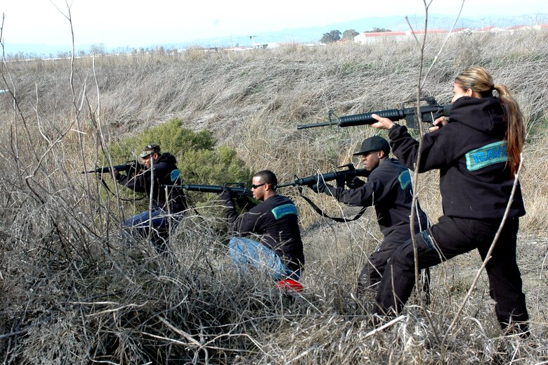 (From left to right) Senior Airman Billy Mims, Staff Sgt. Skylor Hunt, Senior Airman Joshua George and Staff Sgt. Sherry Brown, 60th Security Force Squadron, play “insurgents” during the field exercise portion of the Combat Skills Training course. To add realism to the exercise, both the students and “insurgents” are armed with modified M-16s rifles and blank ammunition and act out fire fights and prisoners of war scenarios in an effort to help teach students how to better react in a combat situation. (U.S. Air Force photo by Staff Sgt. Candy Knight)