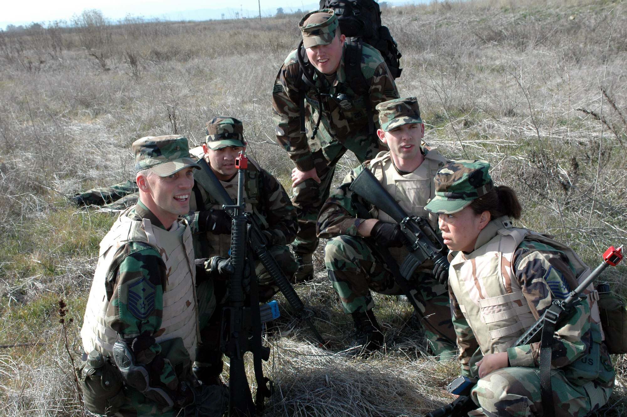Members of Squad #1 discuss battlefield strategy during the Combat Skills Training course. Taught by the 60th Security Forces Squadron, the course gives students a crash course on basic combat survival skills and techniques including individual combat movements, combat troop formations, hand signals, low and high crawling. (U.S. Air Force photo by Staff Sgt. Candy Knight)