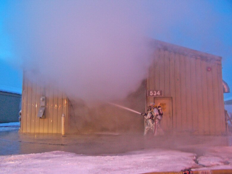 EIELSON AIR FORCE BASE, Alaska -- Firefighters battle a fire at the recylcing center Jan. 18. The recycling center's pelletizer, a piece of equipment designed to process used paper and convert it into pullets to burn in Eielson's power plant, was the source of the fire.