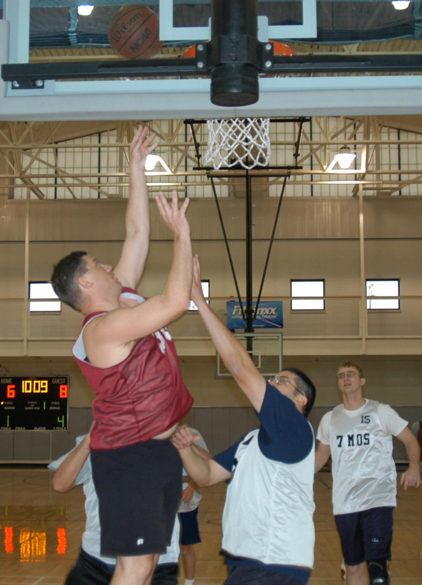 Dyess' 7th Munitions Squadron and 7th Maintenance Operation Squadron skirmish at the net during over-30 basketball Jan. 24.                        