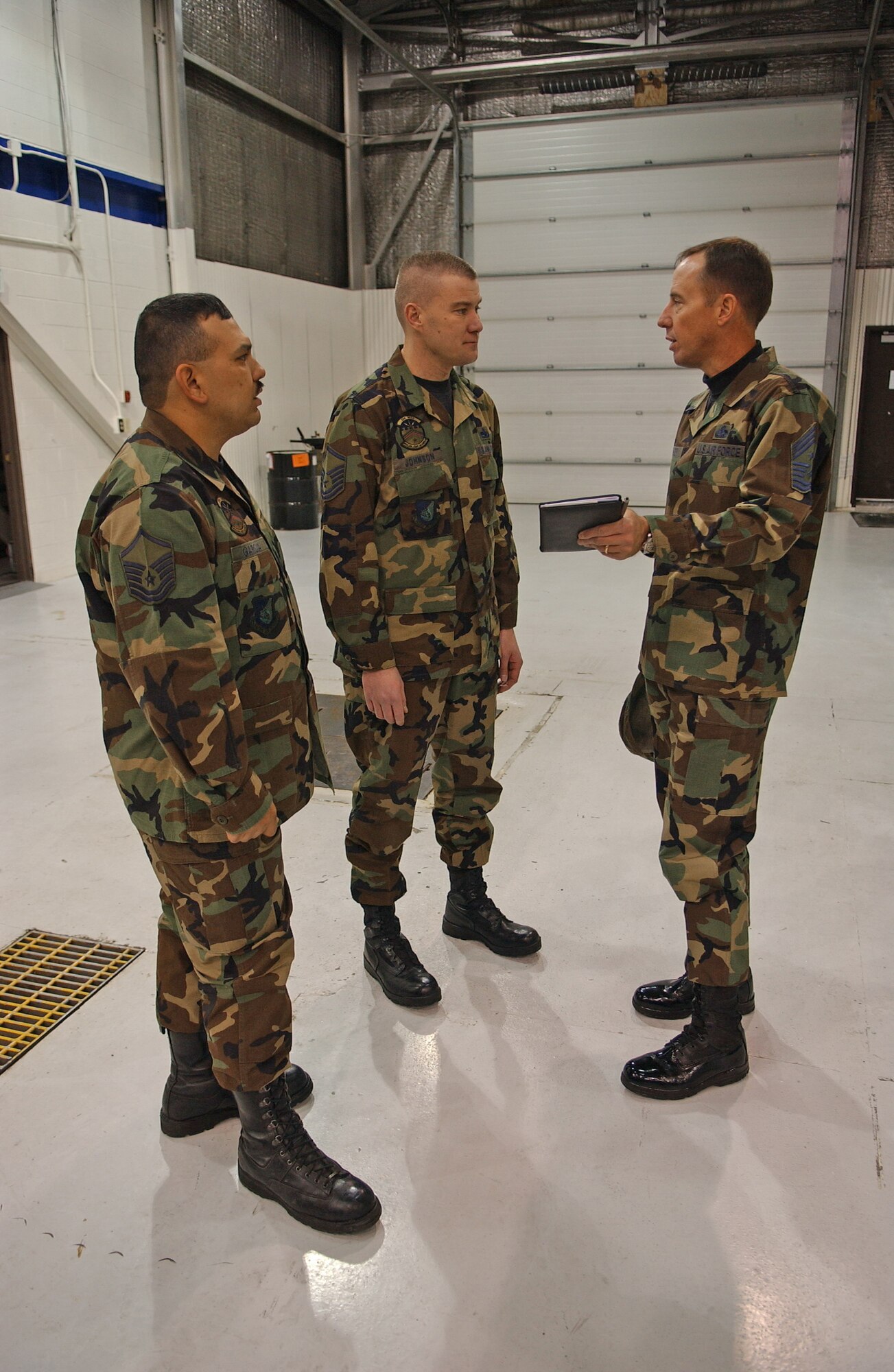 EIELSON AIR FORCE BASE, Alaska--Chief Master Sgt. Anthony Bishop, Pacific Air Forces command chief speaks with Master Sgt. Frank Garcia, 354th Maintenance Squadron assistant maintenance flight chief) and Master Sgt. Bradley Johnson, 354th MXS maintenance flight chief, at the Phase Dock in a maintenance hangar during his visit to Eielson Jan. 17 and 18. 
 (U.S. Air Force Photo by Senior Airman Anthony Nelson) 