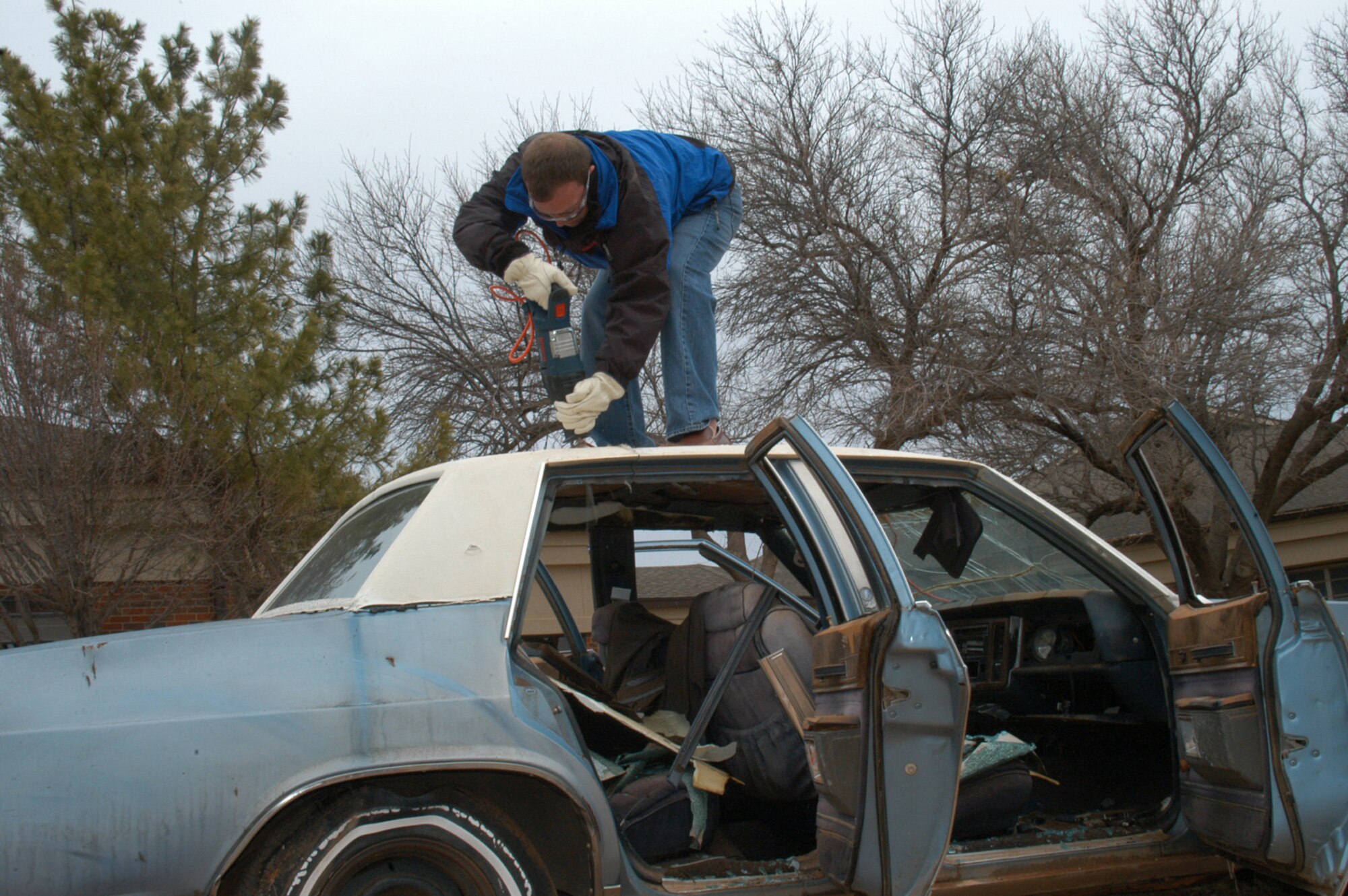 Brian Kirk from Lenox Corporation demonstrates the use of a titanium saw on a car at Dyess Jan. 19.                               