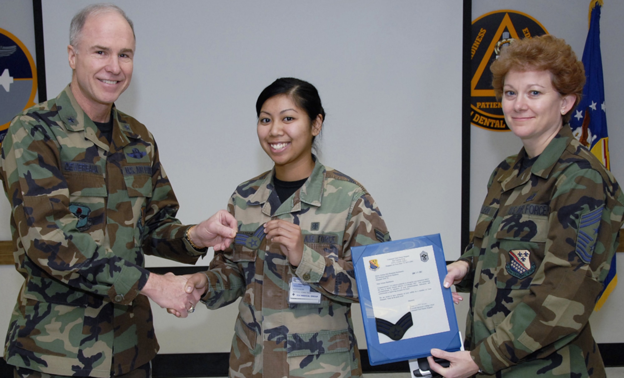 Promoting to the next rank is always good news, especially when it occurs ahead of schedule. The 82nd Medical Support Squadron's Airman 1st Class Reasamai Bunthanom was selected through the Below-the-Zone program to promote early to senior airman. Brig. Gen. Richard Devereaux, 82nd Training Wing commander, and 82nd TRW Command Chief Chief Master Sgt. Jeannie McLean present new stripes for Airman Bunthanom Jan. 19. (U.S. Air Force photo/Sandy Wassenmiller)