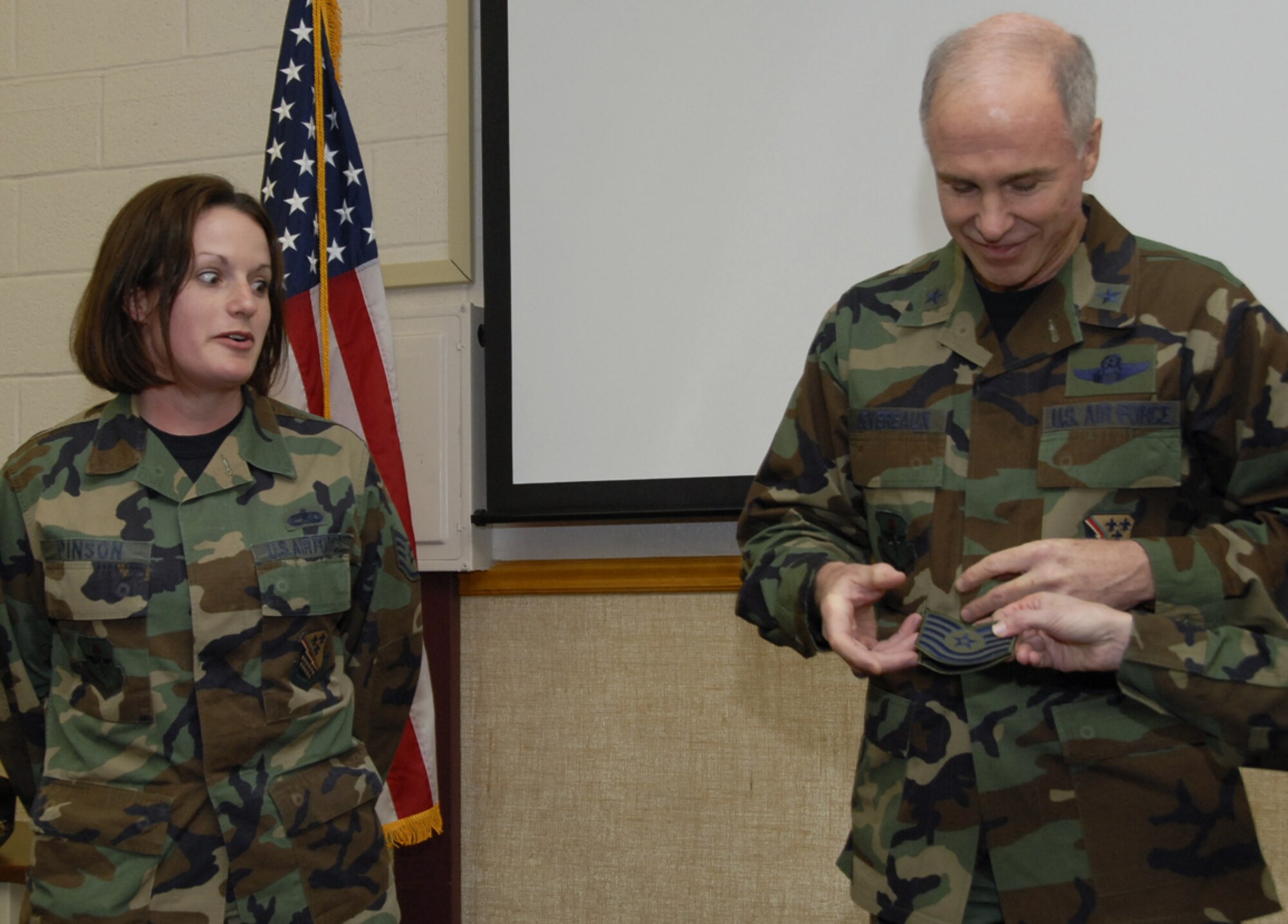 Brig. Gen. Richard Devereaux, right, commander of the 82nd Training Wing, gets ready to present new chevron's to an astonished Staff Sgt. Gail Pinson Jan. 19. The general chose the 982nd Maintenance Squadron's Sergeant Pinson to promote to the next rank through the Stripes for Exception Performers, or STEP, program. (U.S. Air Force photo/Sandy Wassenmiller)