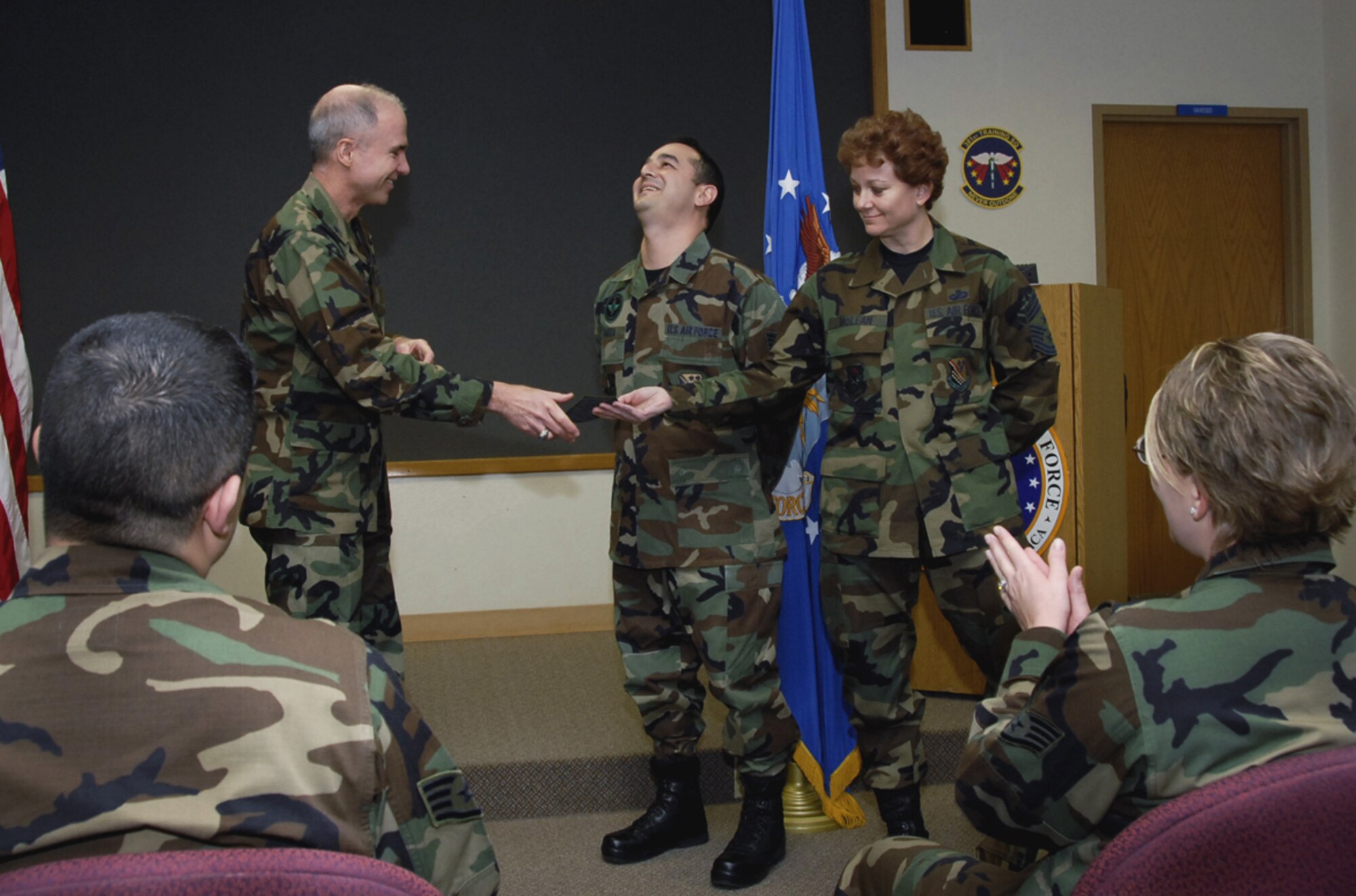 Tech. Sgt. Tim Garza of the 381st Training Squadron reacts to the news of his promotion from 82nd Training Wing Commander Brig. Gen. Richard Devereaux Jan. 19. Sergeant Garza moved up a rank through the Stripes for Exceptional Performers, or STEP, program. (U.S. Air Force photo/Sandy Wassenmiller)