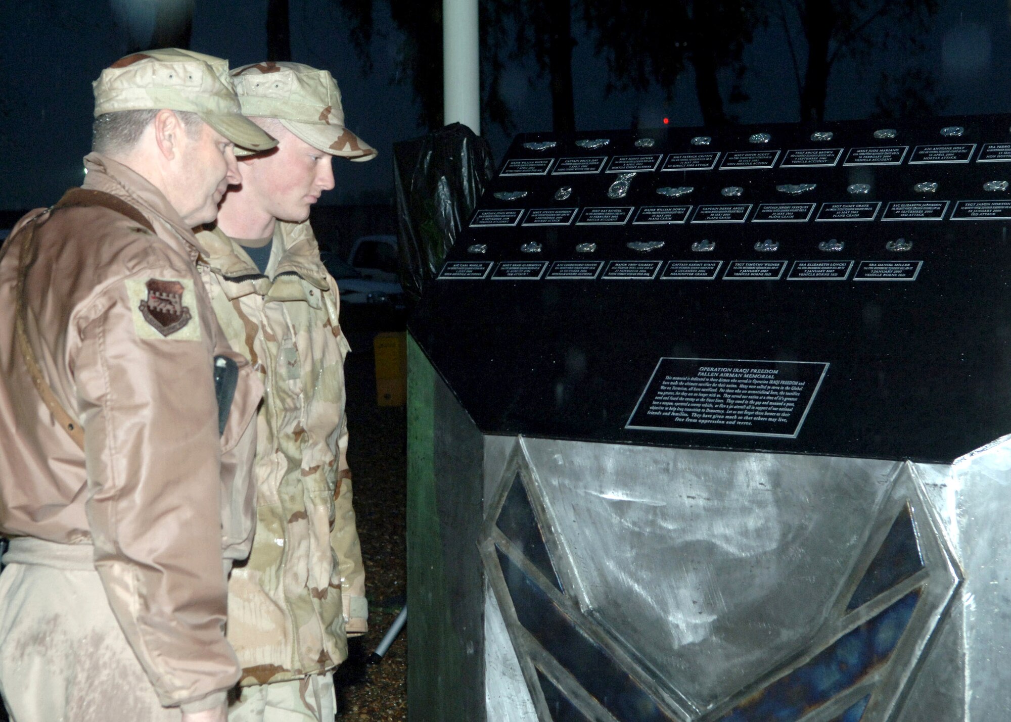 Brig. Gen. Robin Rand and Airman 1st Class Neil Ketchem pay their respects at the 332nd AEW's monument to honor fallen Airmen Jan. 12 at Balad Air Base, Iraq. General Rand is the 332nd Air Expeditionary Wing commander, and Airman Ketchem is a 332nd Expeditionary Civil Engineer Squadron structures journeyman deployed from Hill Air Force Base, Utah. (U.S. Air Force photo/Airman 1st Class Chad Kellum)