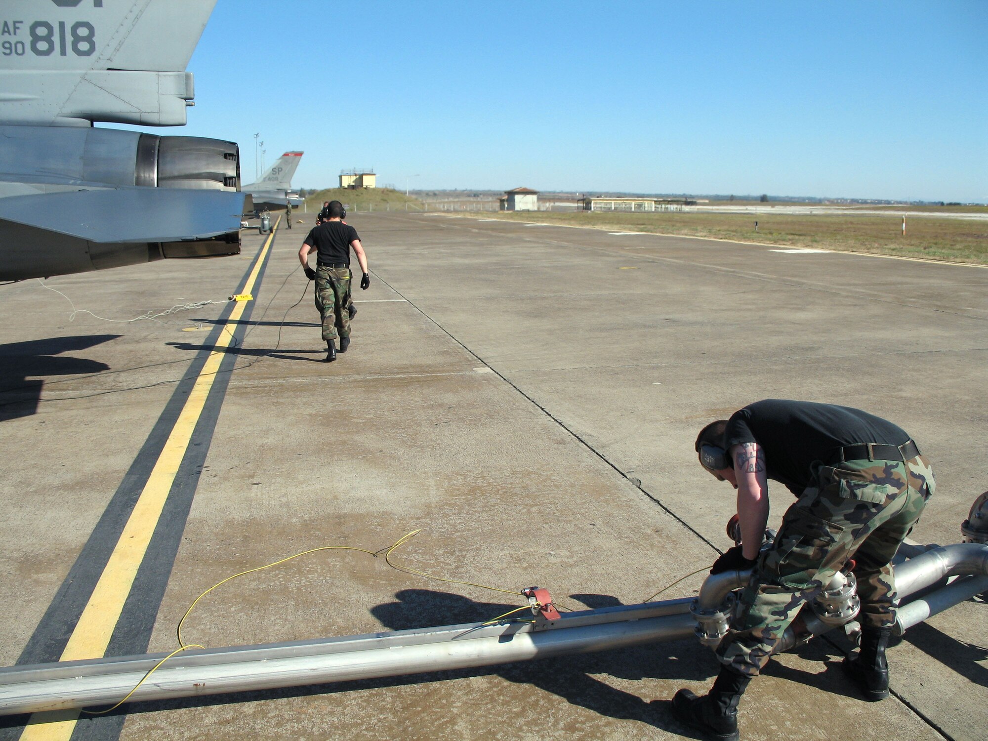 Senior Airman William Murray and Senior Airman Blake Mellom inspect their equipment between "hot pit" refueling Jan. 22 at Incirlik Air Base, Turkey. Airman Murray is assigned to the 52nd Aircraft Maintenance Squadron and Airman Mellom is from the 52nd Logistics Readiness Squadron, both from Spangdalhem Air Base, Germany, in support of the 22nd Expeditionary Fighter Squadron. (U.S. Air Force photo/Airman 1st Class Thomas Kennedy) 