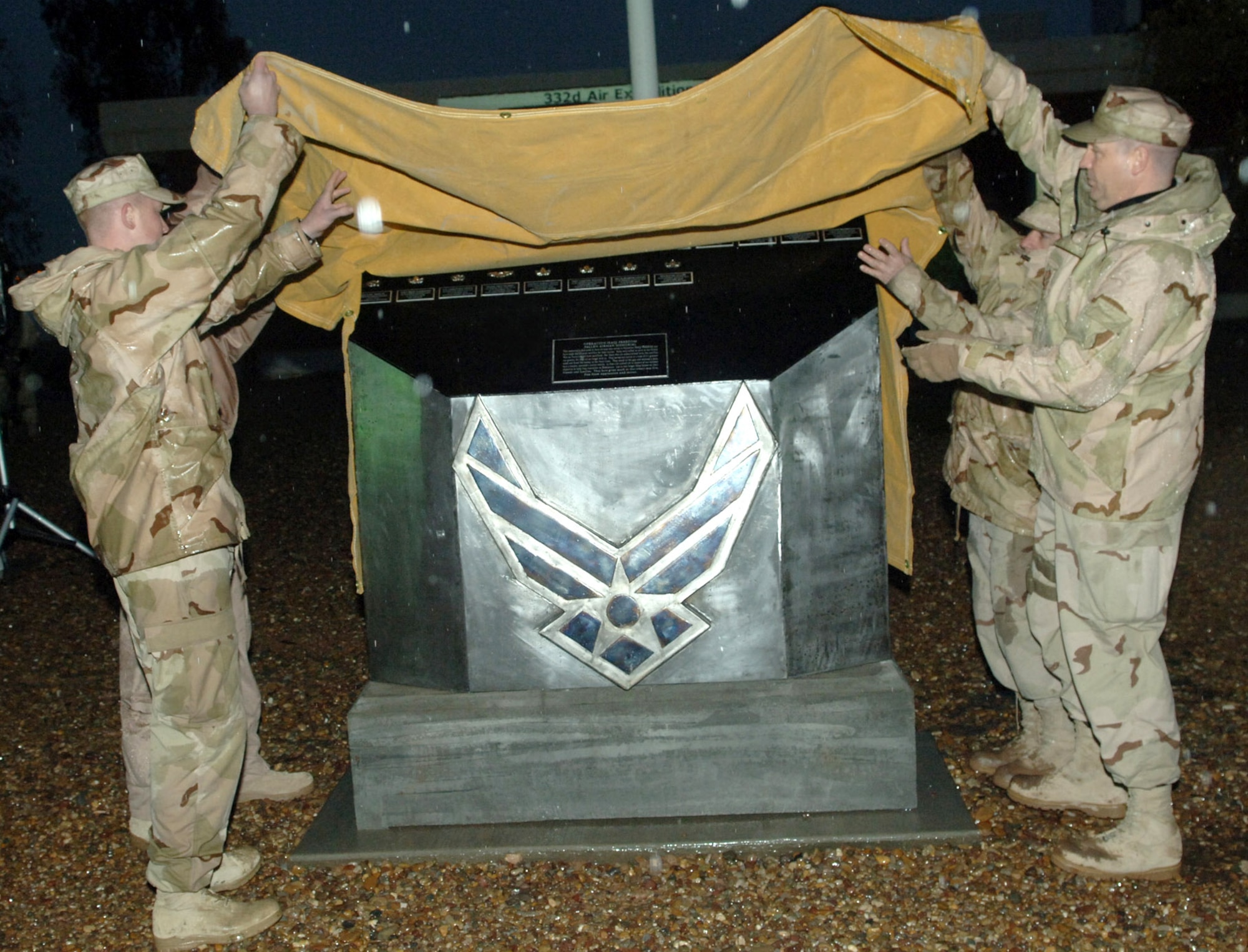 Airmen unveil the 332nd Air Expeditionary Wing's new monument to honor fallen Airmen during a ceremony Jan. 12 at Balad Air Base, Iraq. (U.S. Air Force photo/Airman 1st Class Chad Kellum) 