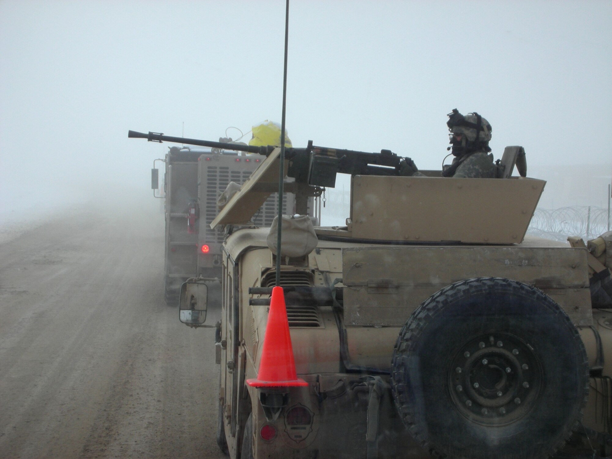 An Army Humvee turret gunner guards a P-19 airport rescue firefighting vehicle operated by the 379th Expeditionary Civil Engineer Squadron Fire and Emergency Services Flex Team during an operation in Southwest Asia. Flex Team deploys at a moment's notice to forward-operating bases to provide aircraft rescue, emergency medical and firefighting support whenever and wherever needed. (U.S. Air Force photo)
