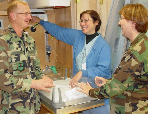 Colonel Roshetko, left, is briefed about a newborn warmer in a labor, delivery, recovery and postpartum room by  Capt. Toni Olivieri, a labor and delivery nurse, and Maj. Regina Paden, a nurse midwife.  Captain Olivieri and Major Paden are members of the squadron’s state-of-the art LDRP unit which opened Jan. 8.  (U.S. Air Force photo by Steve Pivnick)