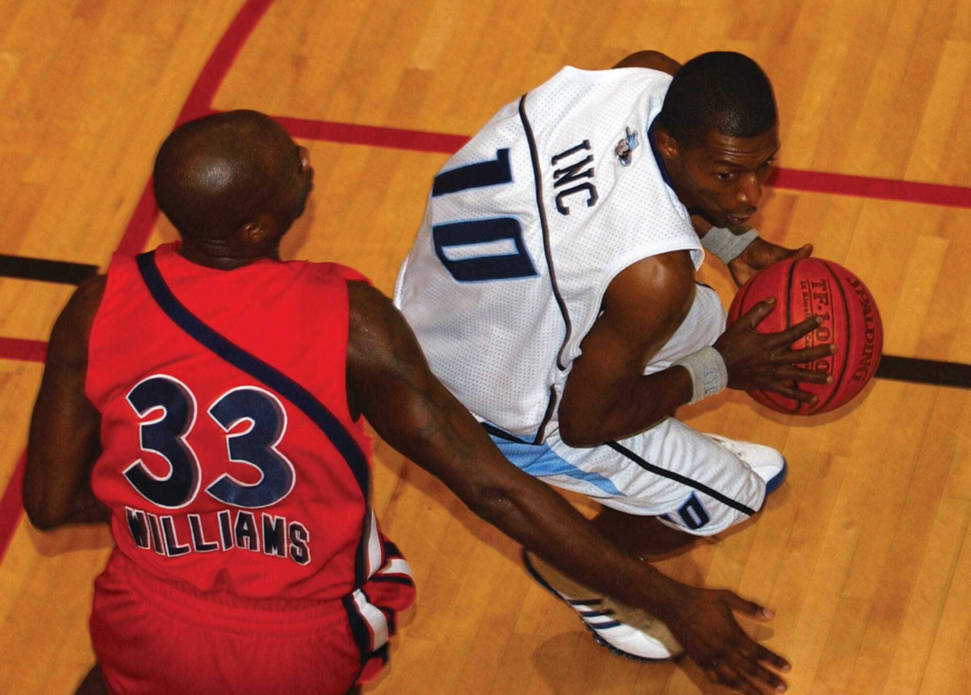 OSAN AIR BASE, Republic of Korea --  Janus Williams, Defender 33, tries to stop a Yongsan player as he attempts to drive to the hoop during Wednesday’s final game. (U.S. Air Force photo by Airman Ruthann Holcomb)