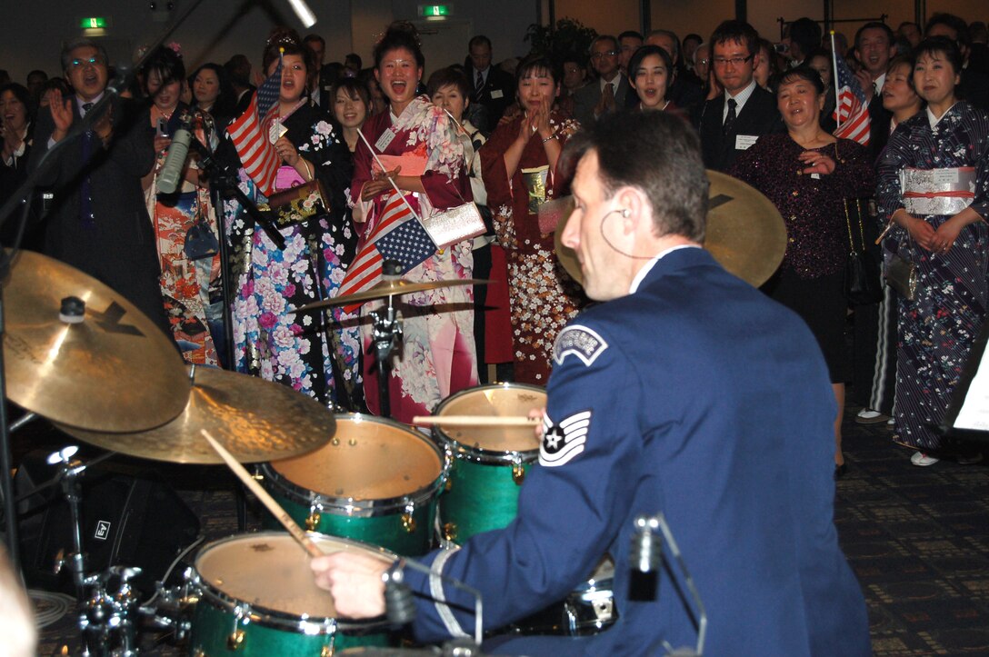 YOKOTA AIR BASE, Japan -- Tech Sgt. Dean Macomber, noncomissioned officer in charge of the Pacific Showcase, thrills more than 320 Japanese and American guests during a New Year's celebration here Jan. 21. The party held between between Yokota Air Base and four surrounding friendship clubs welcomed in the new year in hopes of greater cooperation between the United States and Japan.