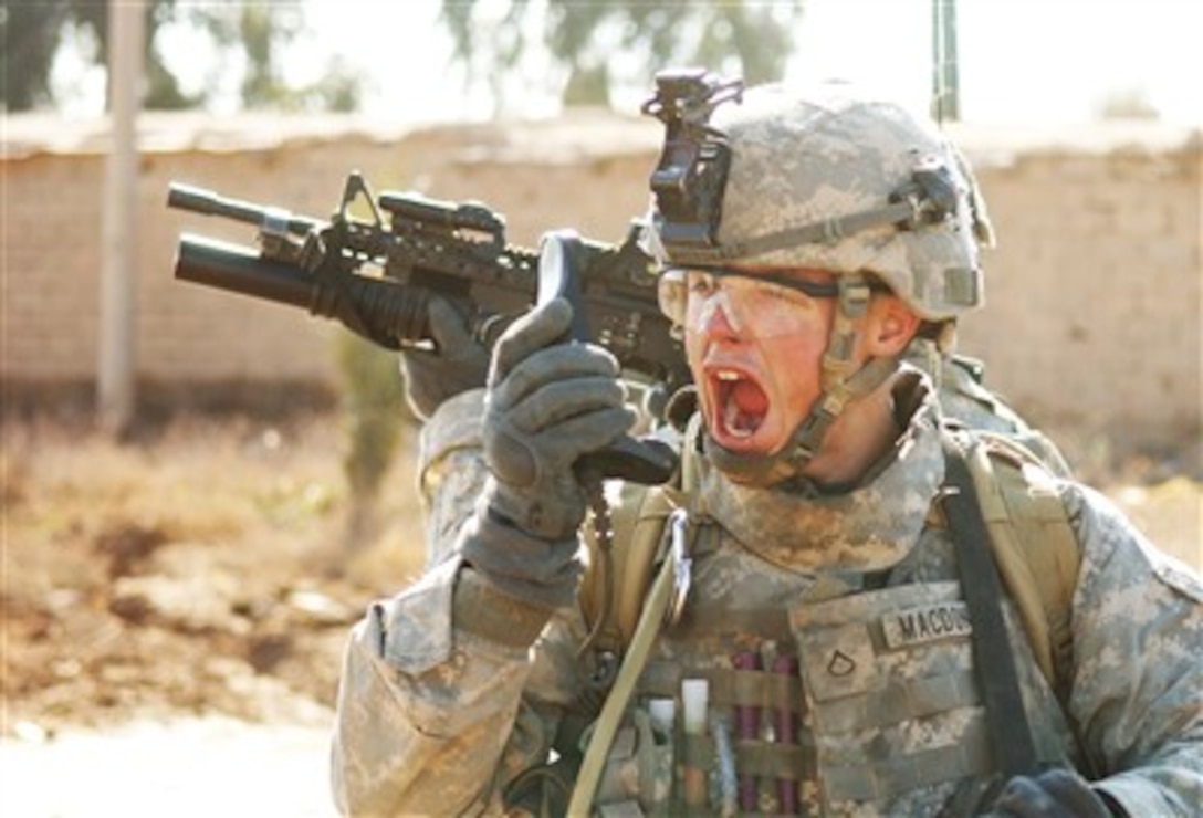 A U.S. Army soldier from the 5th Squadron, 73rd Cavalry Regiment relays information to other members of his unit through his radio during an operation to neutralize insurgents in Balad, Iraq, on Jan. 7, 2007.  