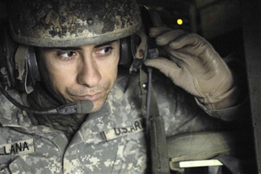 U.S. Army Sgt. 1st Class Carlos Santillana listens to a mission brief inside an M2A2 Bradley Fighting Vehicle in Baqubah, Iraq, on Jan. 23, 2007.  Santillana is assigned to Alpha Company, 1st Cavalry Division, 12th Infantry Regiment.  