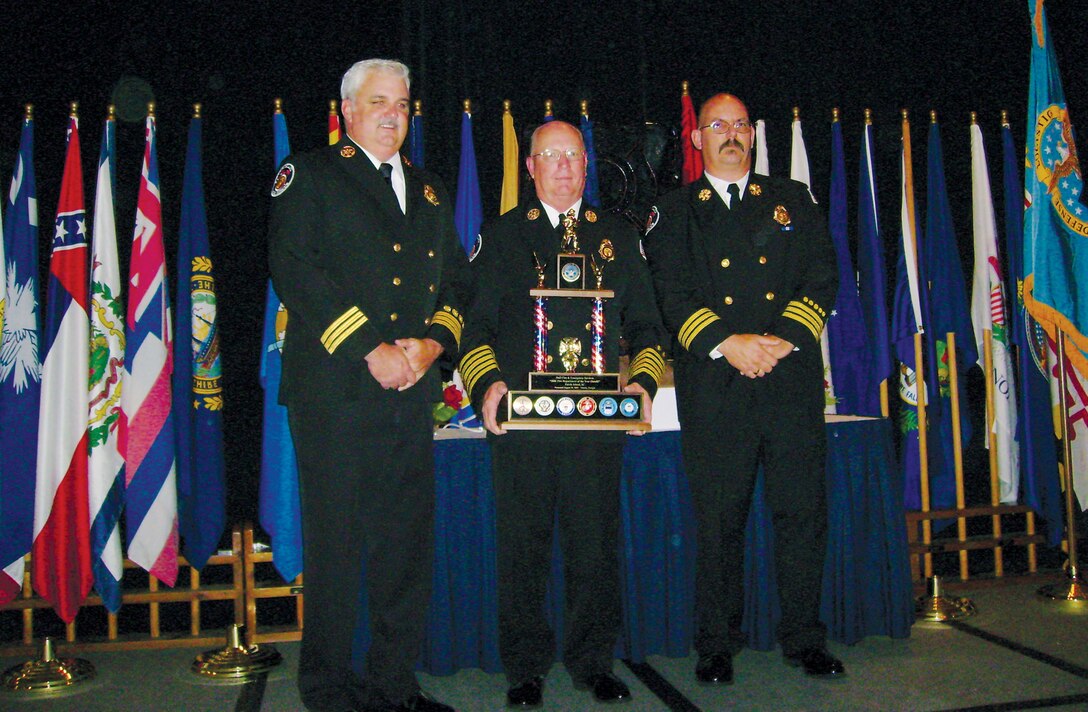 (From left) Parris Island Fire Rescue Division Assistant Chief of Prevention Geoffrey Lee, Fire Chief Kelvin Canaday and Assistant Chief of Training/EMS Dwight Charleston display the fire department's DoD Fire Department of the Year plaque at the DoD Awards Banquet in Atlanta Aug. 24.