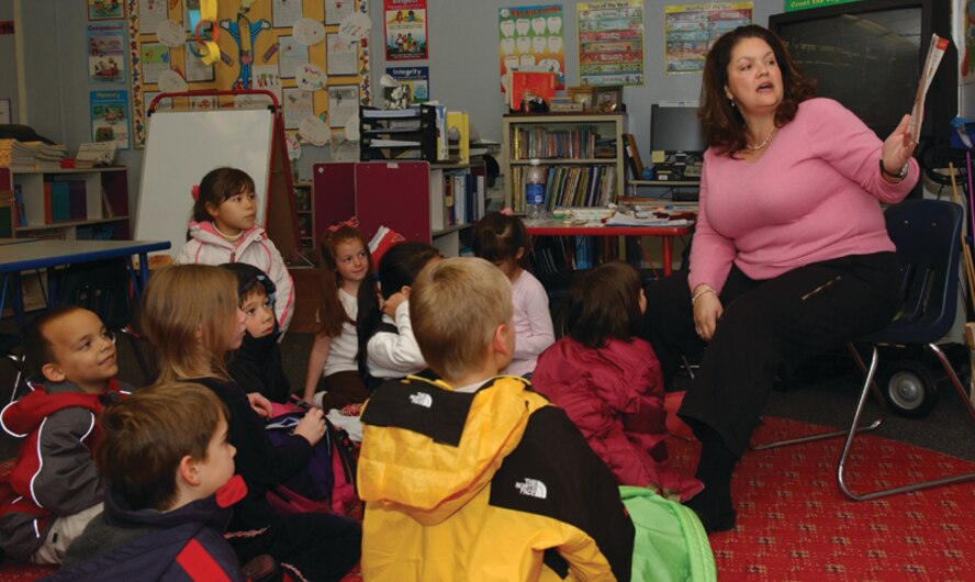 OSAN AIR BASE, Republic of Korea --  Mrs. Charlotte Bardin, 1st grade teacher, reads a book to her students as they wait to be released for the day. There are often job openings in the Department of Defense Dependent's Schools at Osan and Camp Humphreys. (U.S. Air Force photo by Senior Airman Eunique Stevens)