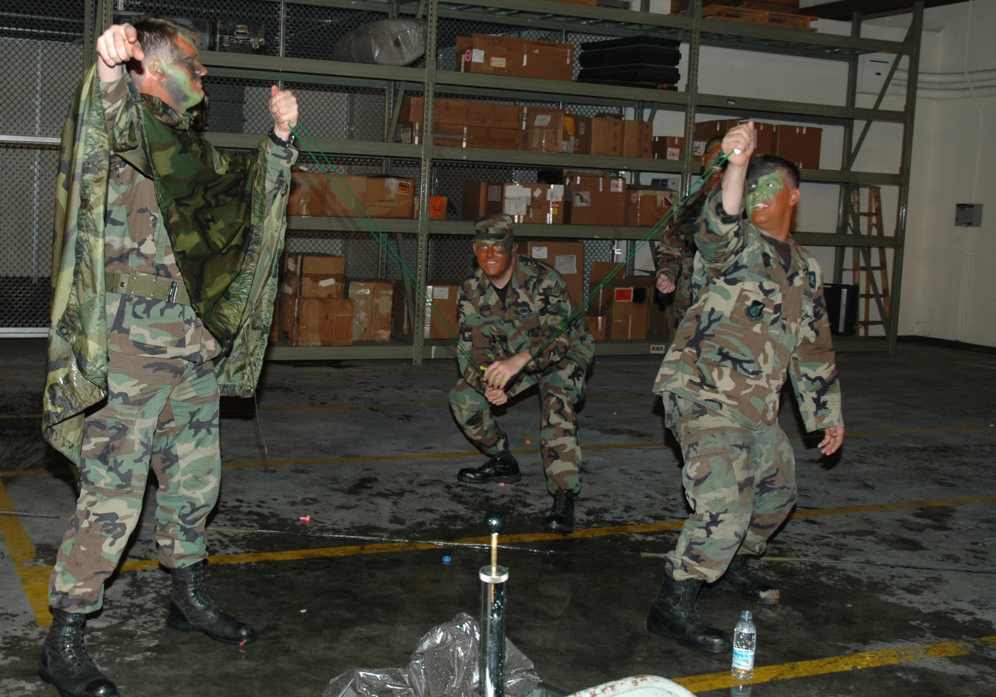 OSAN AIR BASE, Republic of Korea --  A trio of 51st Maintenance Squadron aircraft maintainers returns fire using a launch platform to hurl their water-filled cannon balls toward the field of battle. The Osan 5/6 Club hosted the first Team Osan 'Enlisted Only' Combat Dining-In Saturday at the traffic management office warehouse in Bldg 635. (U.S. Air Force photo by Tech. Sgt. Michael O'Connor)