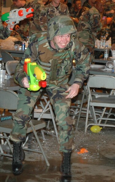 OSAN AIR BASE, Republic of Korea --  Tech. Sgt. Jerol Boyce, 51st Fighter Wing legal office, dodges a stray balloon thrown at someone running the obstacle course. The Osan 5/6 Club hosted the first Team Osan 'Enlisted Only' Combat Dining-In Saturday at the traffic management office warehouse in Bldg 635. (U.S. Air Force photo by Tech. Sgt. Michael O'Connor)