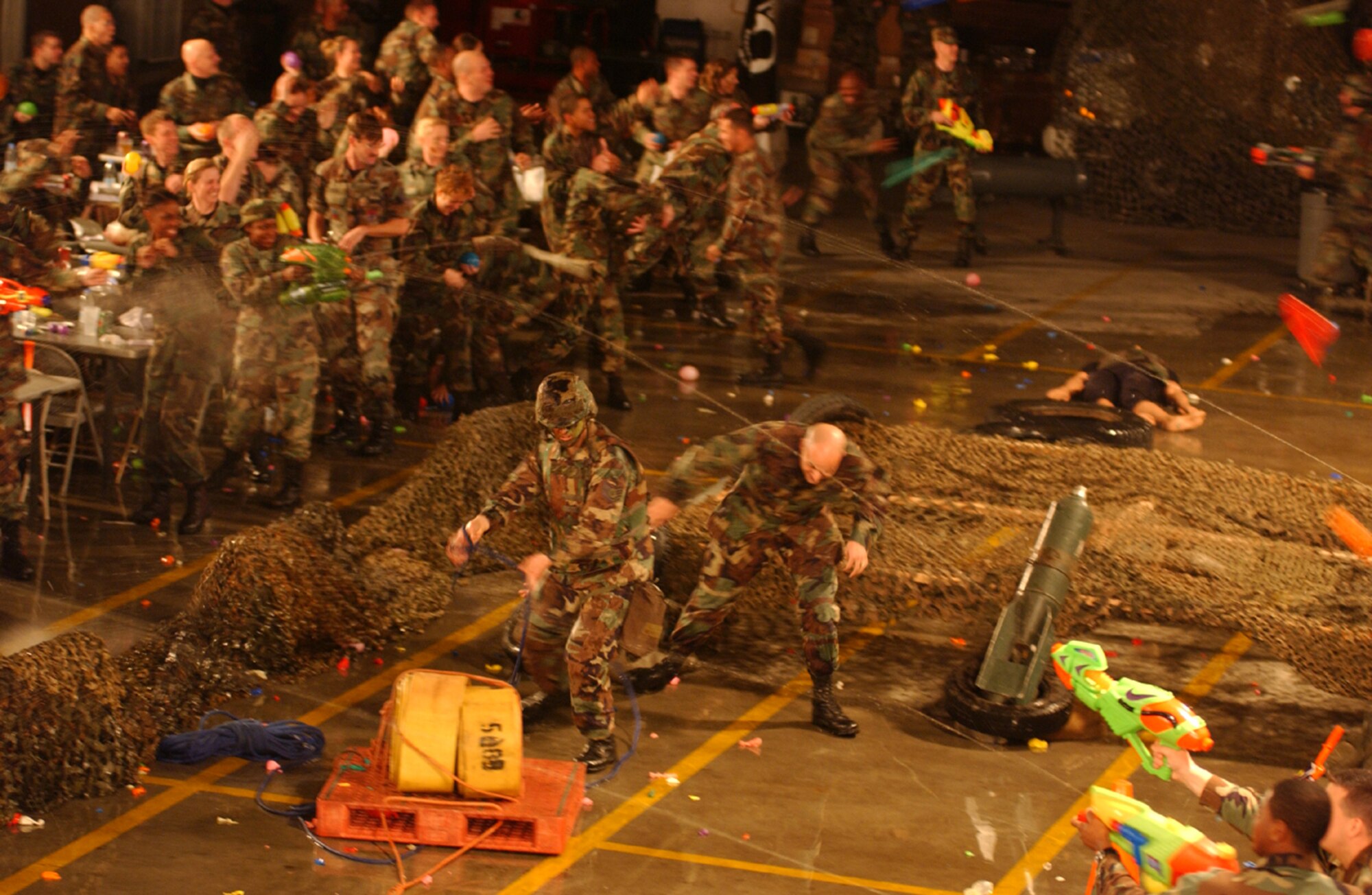 OSAN AIR BASE, Republic of Korea --  Combatants who violated the rules of the mess are required to take a trip to the grog. However, in order to get to the grog,combatants had to go through a five-part obstacle course with a Wingman. Together, both combatants had to pull a pallet with two fire hoses weighing approximately 140 pounds twenty feet, ride two children’s bicycles with training wheels though a set of cones, low crawl twenty feet, then maneuver through a series of tires before pulling two 140-pound wounded combatant dummies twenty feet to safety. The Osan 5/6 Club hosted the first Team Osan 'Enlisted Only' Combat Dining-In Nov. 30 at the traffic management office warehouse in Bldg 635. (U.S. Air Force photo by Staff Sgt. Chrissy Fitzgerald)