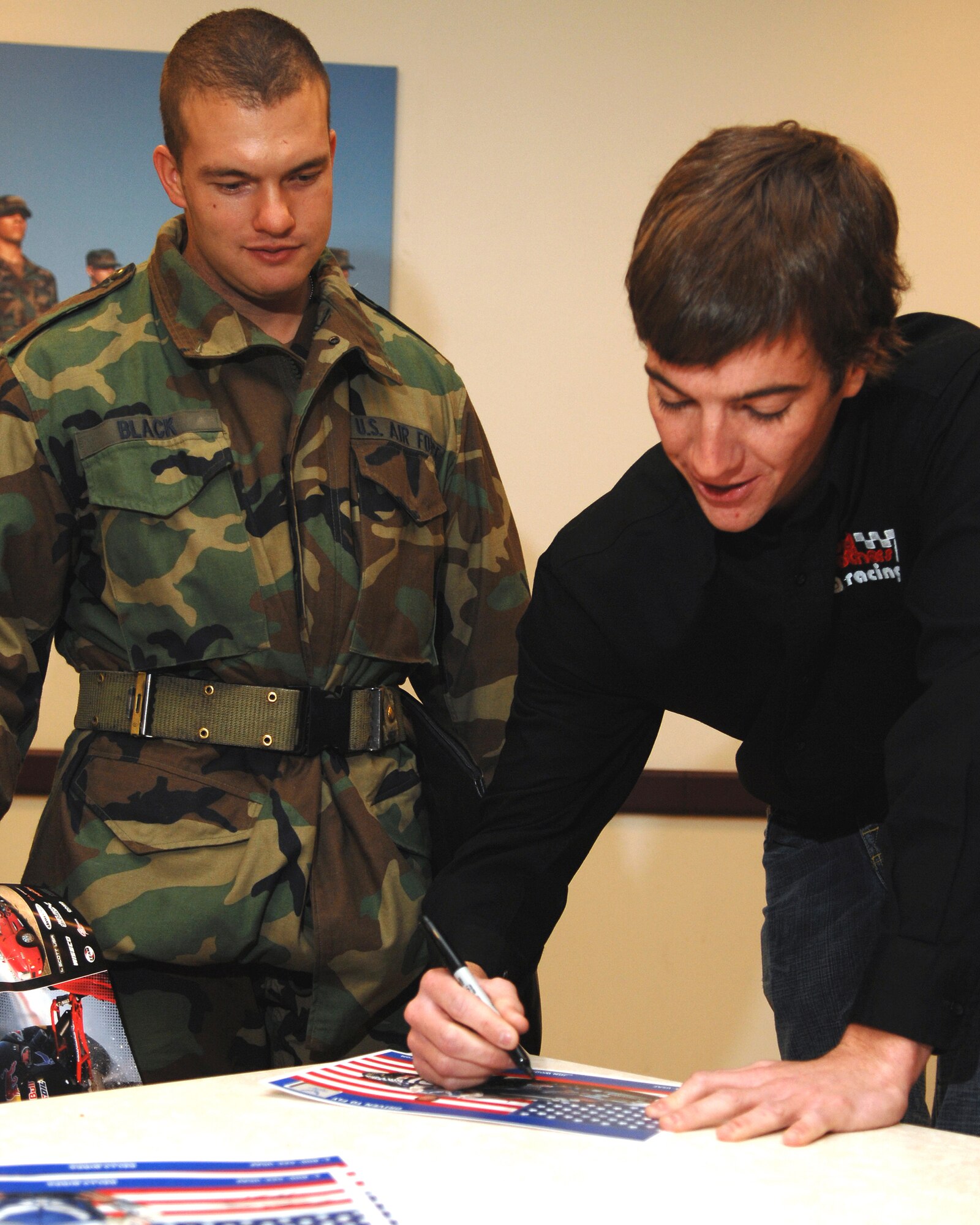 LACKLAND AFB, Texas -- Jon Wood, right, new driver of the Air Force-sponsored NASCAR No. 21, signs an autograph for basic trainee Airman Basic Black during an Air Force basic military training orientation tour Jan. 16, 2007, on Lackland Air Force Base, Texas. Sponsorship of NASCAR No. 21 promotes Air Force awareness by providing a venue to share career opportunities with men and women ages 17-27, the Air Force’s main recruiting demographic. (U.S. Air Force photo by Master Sgt. Scott Reed)