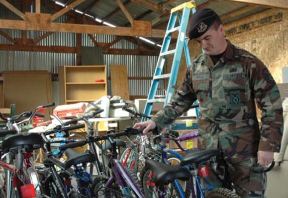 Tech. Sgt. George F. Roach, a security forces member here and Vice President of AFSA’s Tucson chapter, steadies one of the 26 bicycles donated to Esperanza En Escalante, a local transitional housing program for homeless veterans.
