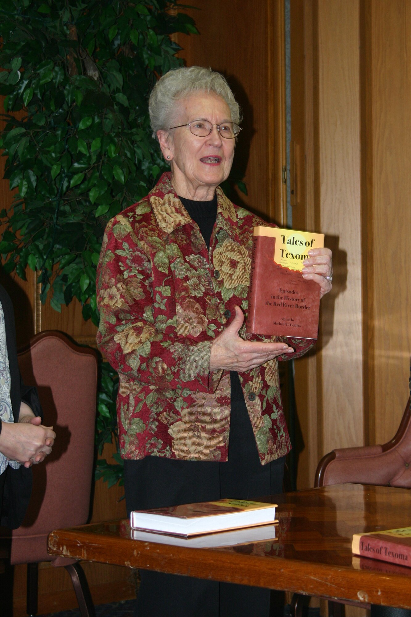 Mrs. Jackie Driver, widow of former 89th district judge Temple Driver, accepts an autographed copy of the book "Tales of Texoma" from the Sheppard AFB Military Officers Association of America. (Photo by SSgt Tonnette Thompson)